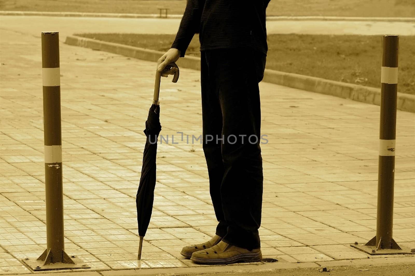 Abstract picture of a waiting person with umbrella