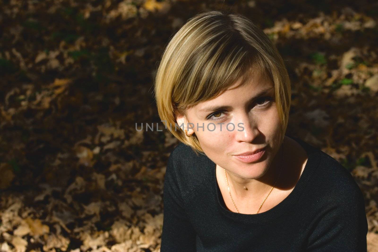 Nice young girl walking in the autumn park