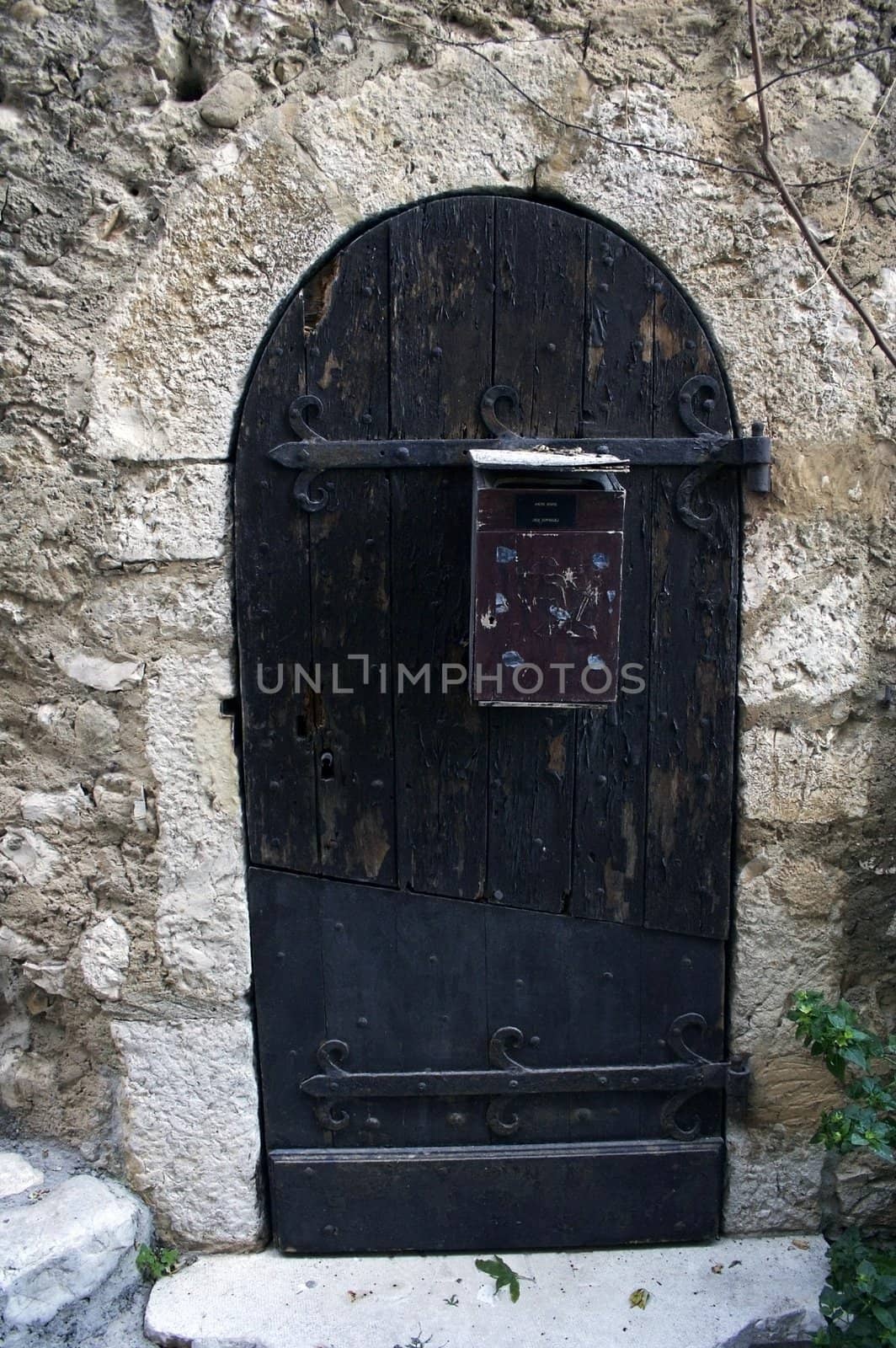 Old door with the postbox in the ancient house