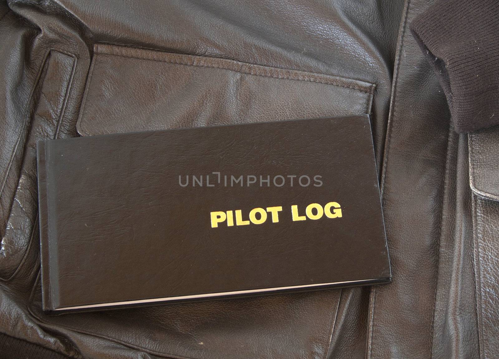 A Pilots log sits on top of a leather A4 aviator jacket