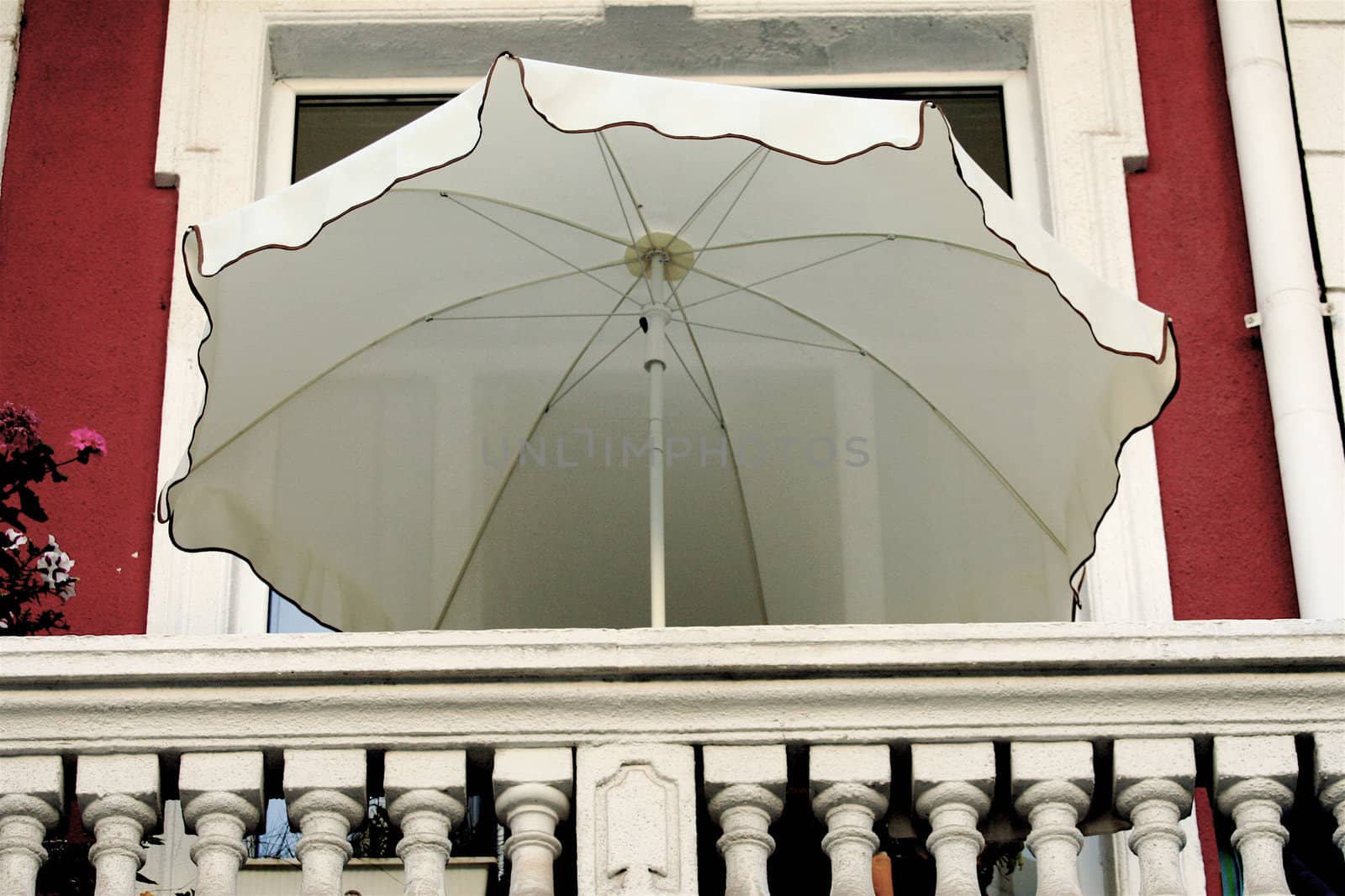 Umbrella staying on the balcony because of the hot weather