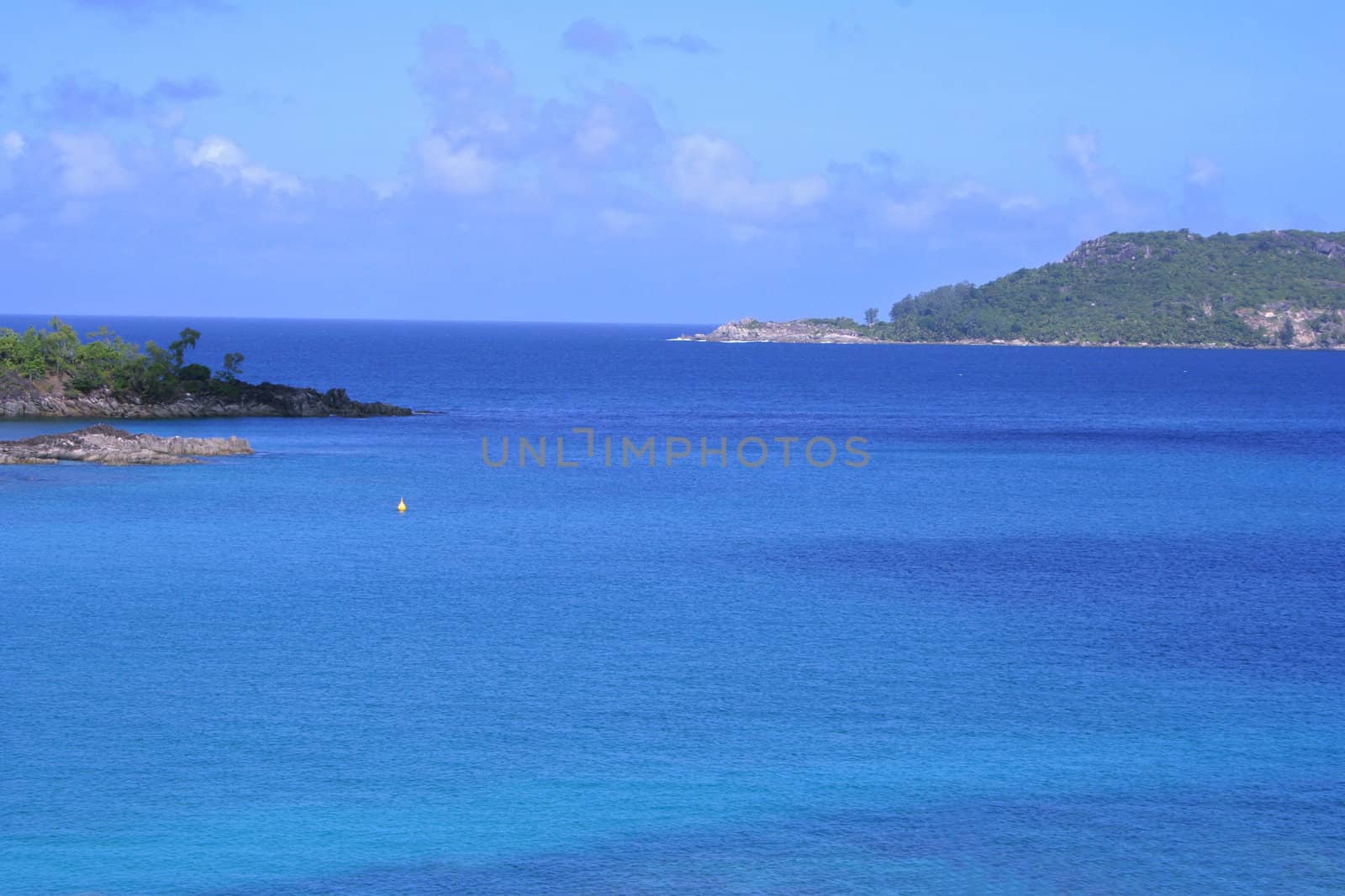 Blue idyllic lagoon with several tropical islands in the ocean