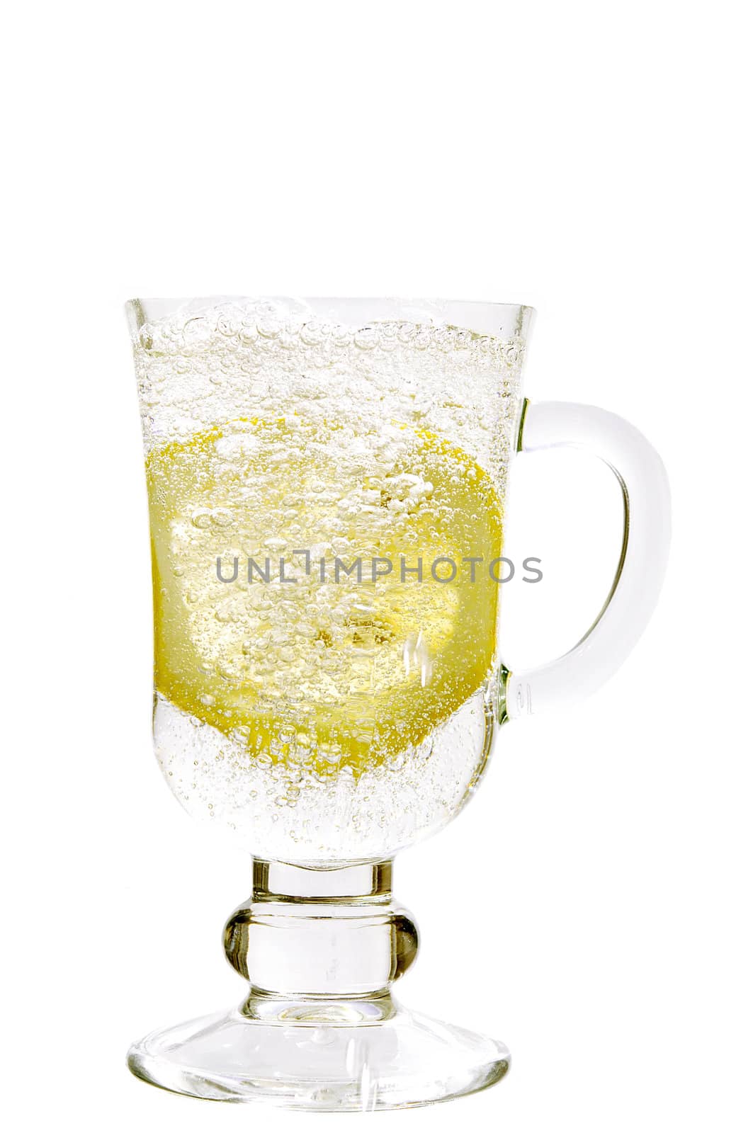 Mineral water in a glass with a lemon on the white isolated background
