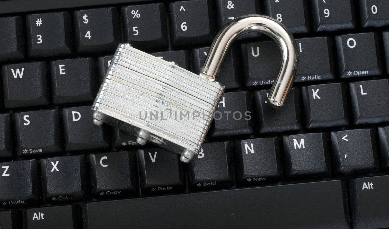 Unlocked padlock on keyboard representing an information security breach