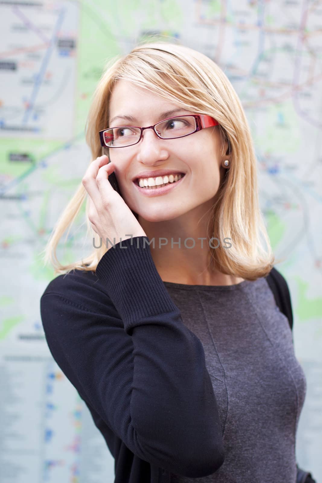 Business woman talking by cell phone infront of the metro map.