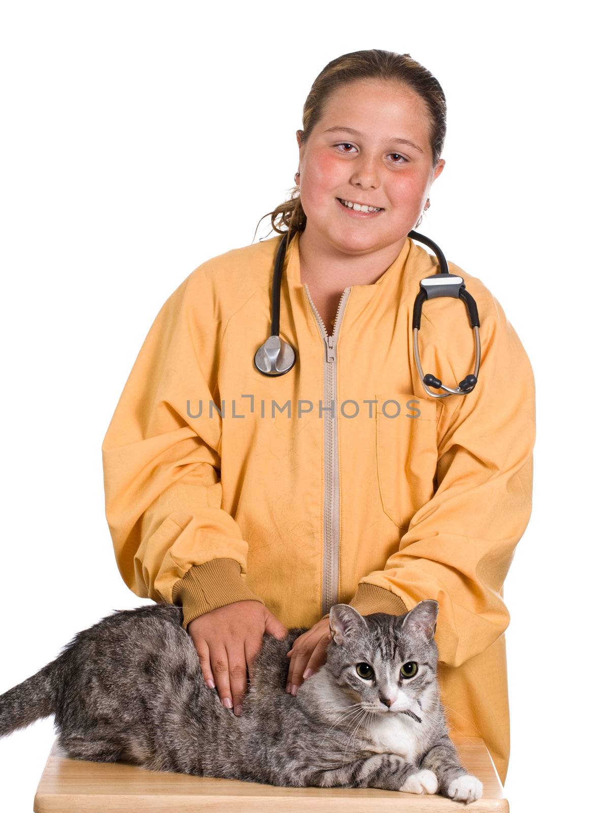 A young girl looking after her pet cat as he sits on a small table 