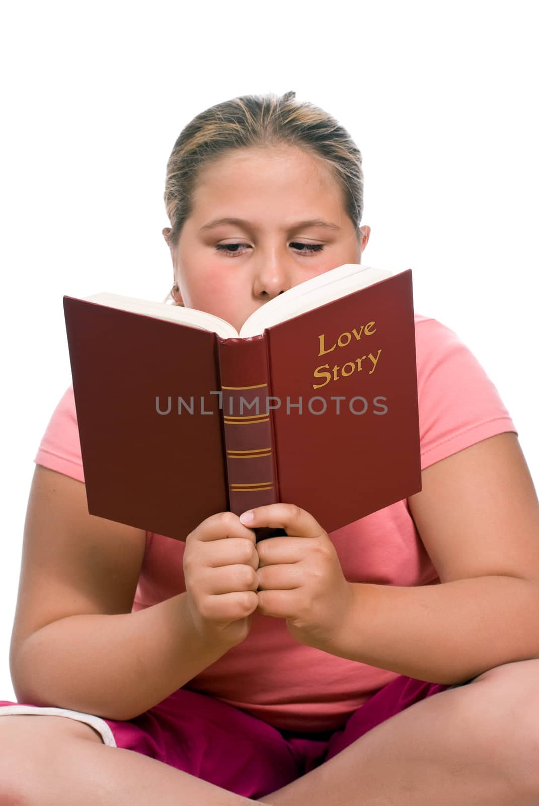 Preteen girl sitting down to read a love story, isolated against a white background