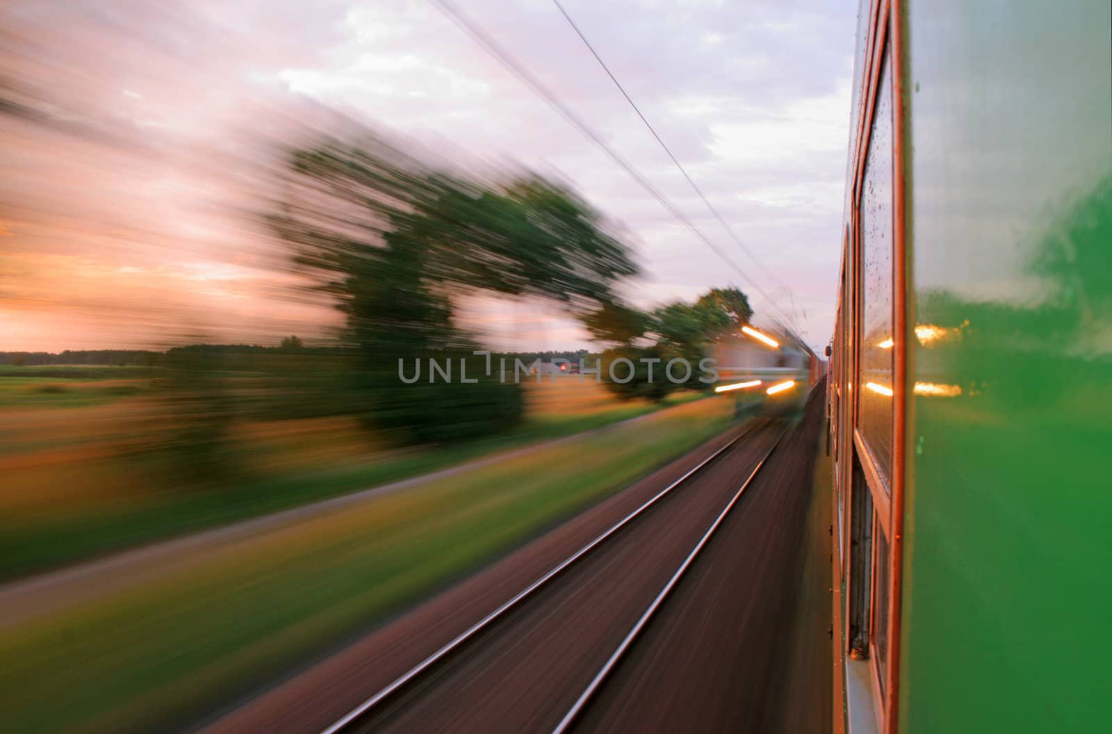 Two trains passing in opposite directions with motion blur
