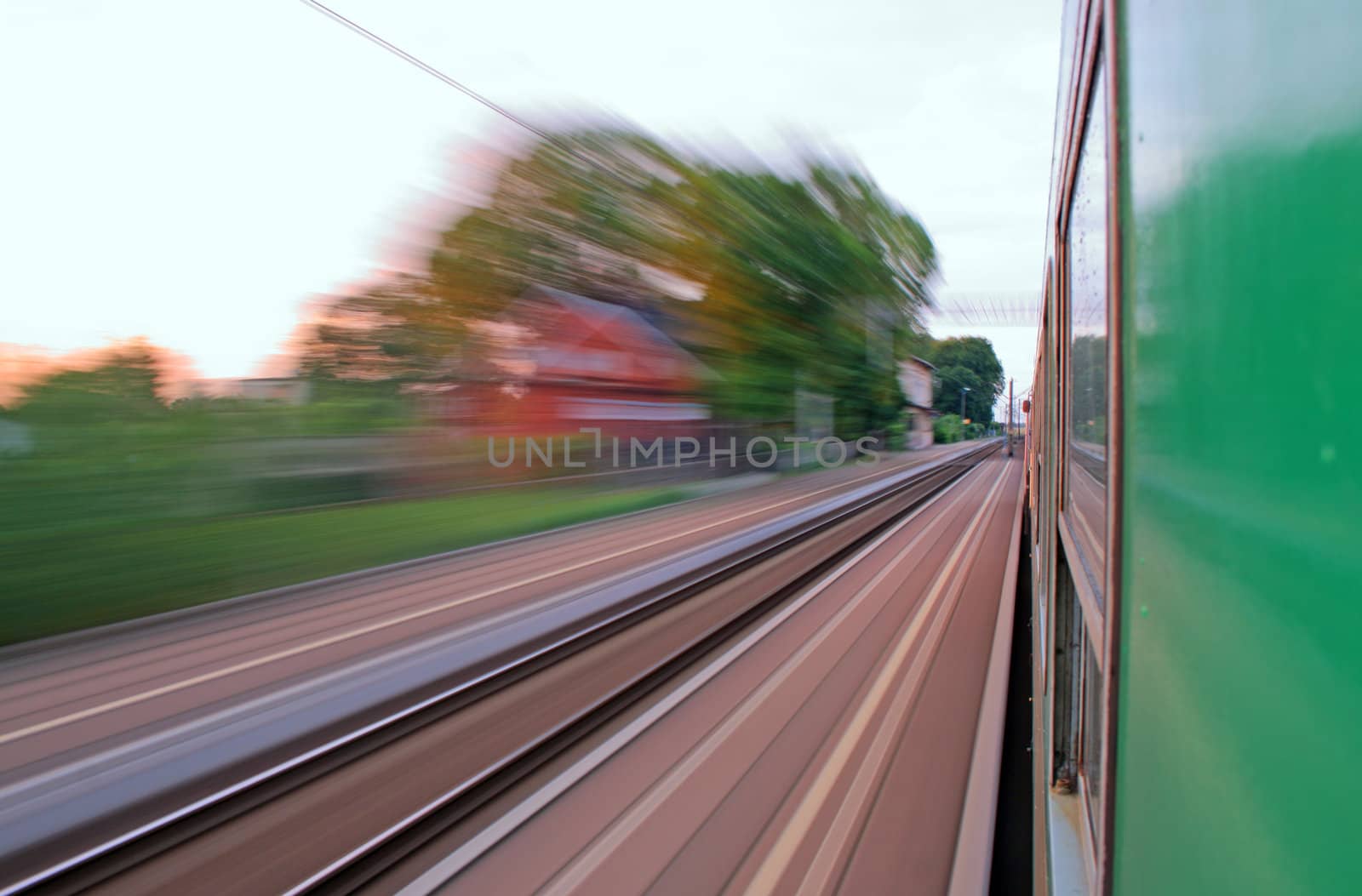 Train passing the station at the high speed with motion blur
