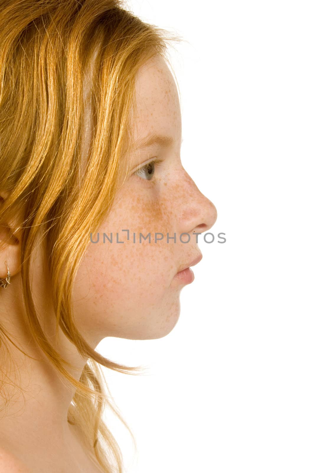 side portrait of young redhead teenage girl with freckles on white