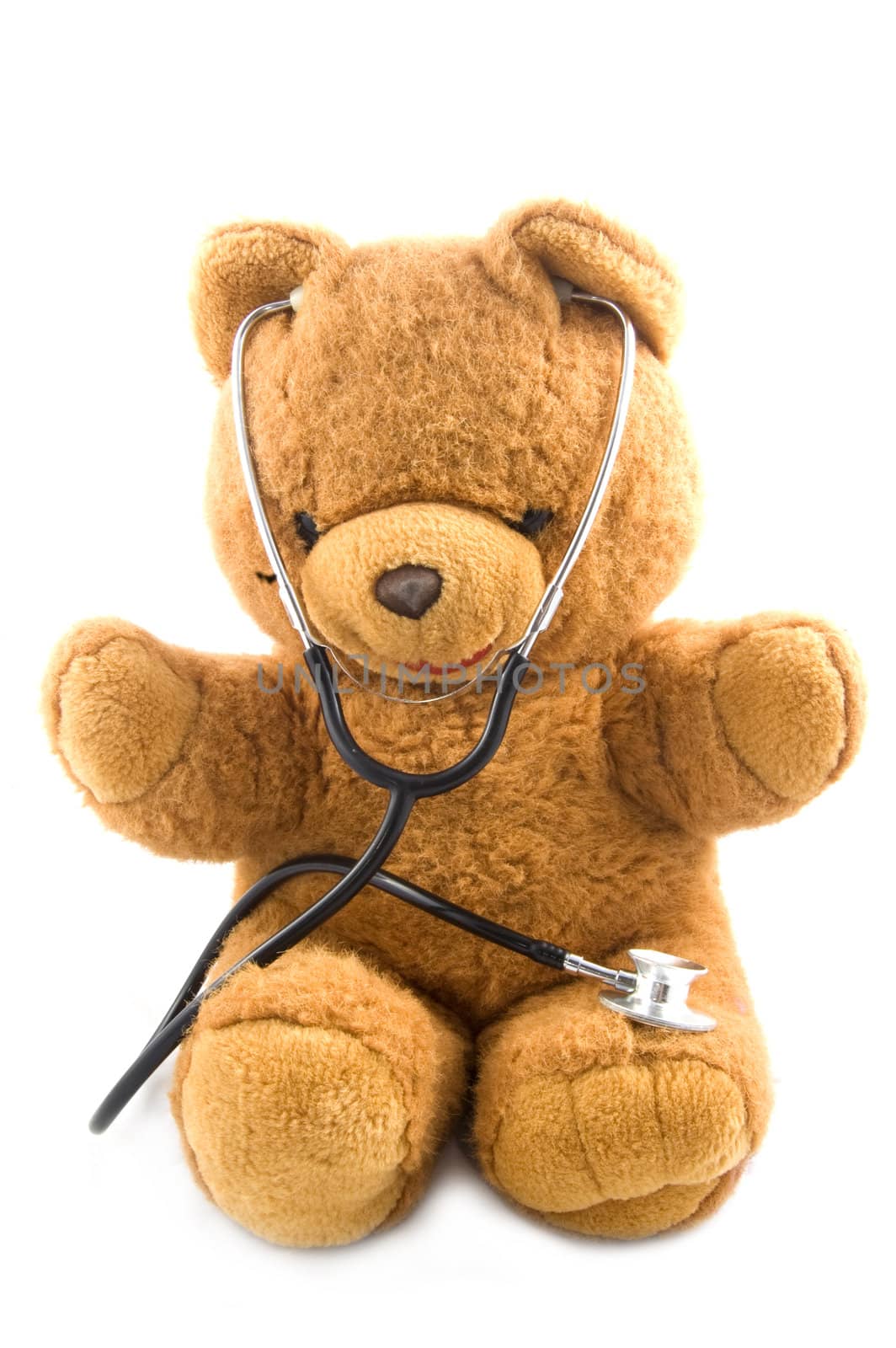 Bown teddybear acting as a doctor with a stetoscope isolated on white