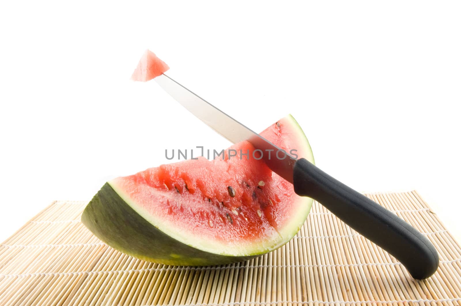 slice of a watermelon with a knife with piece of the watermelon by ladyminnie
