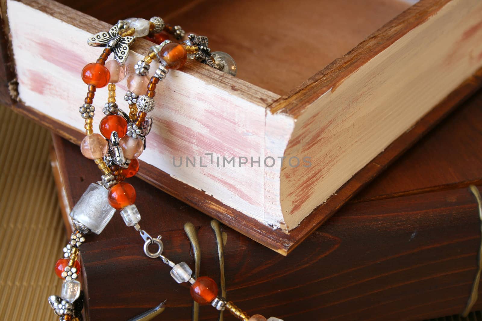 Orange Jewellery hanging from an open wooden jewellery box