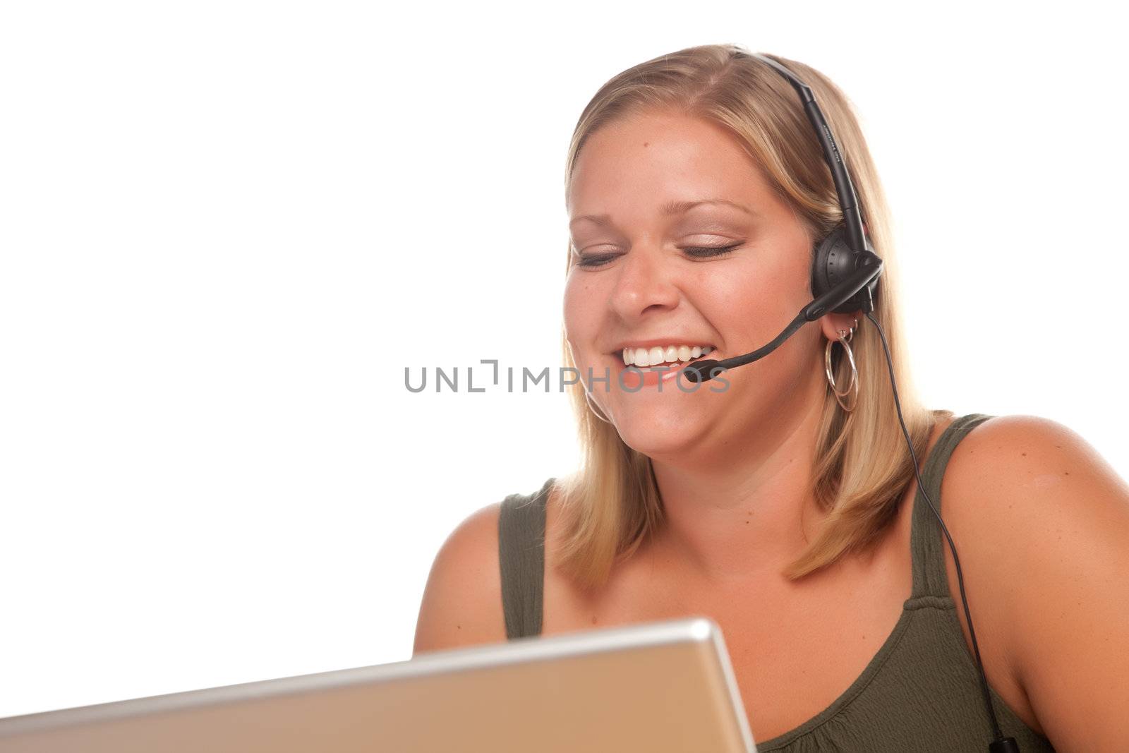 Attractive businesswoman smiles as she talks on her phone headset.