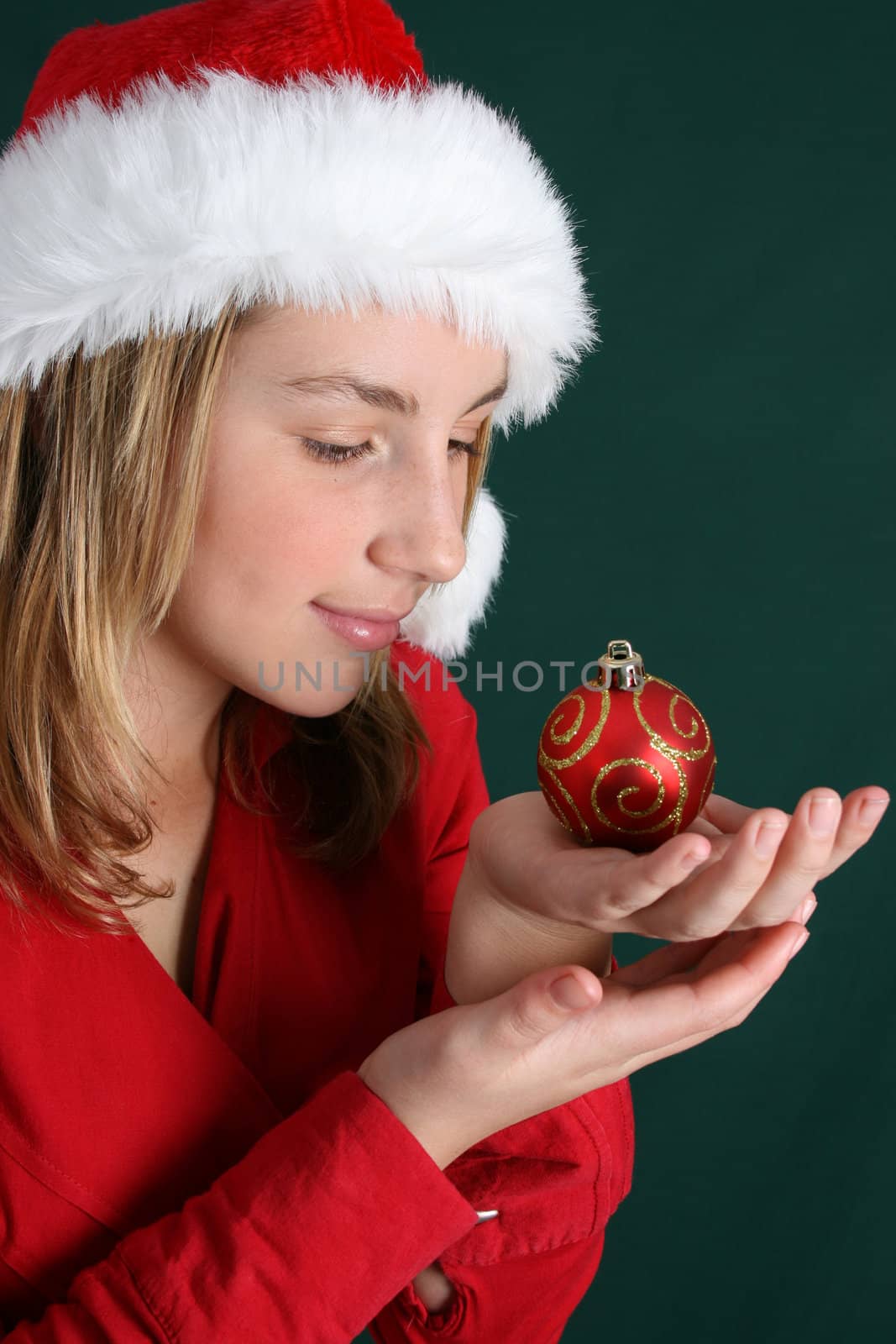 Beautiful teenager wearing a red shirt and christmas hat