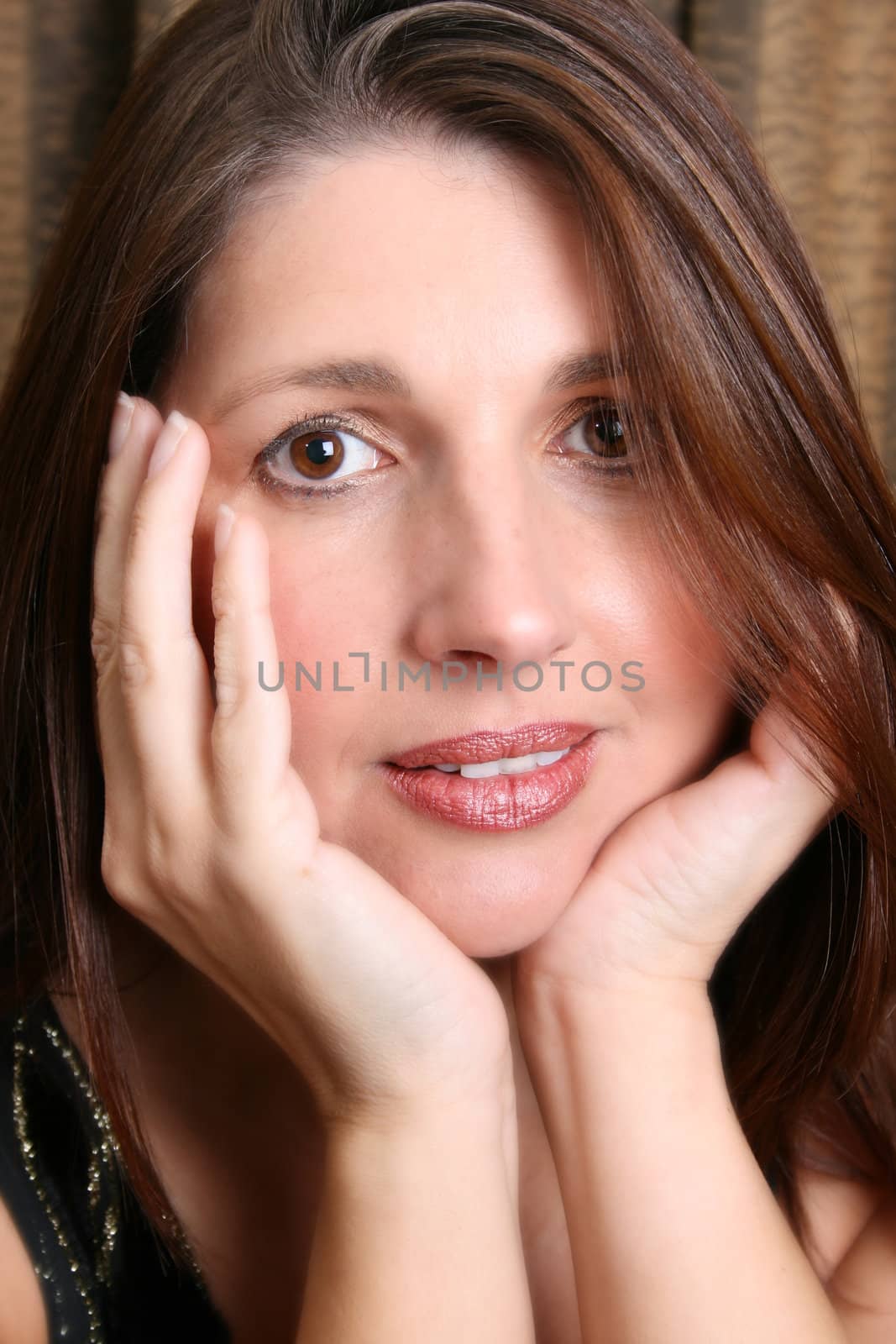 Beautiful brunette female model against a dark background