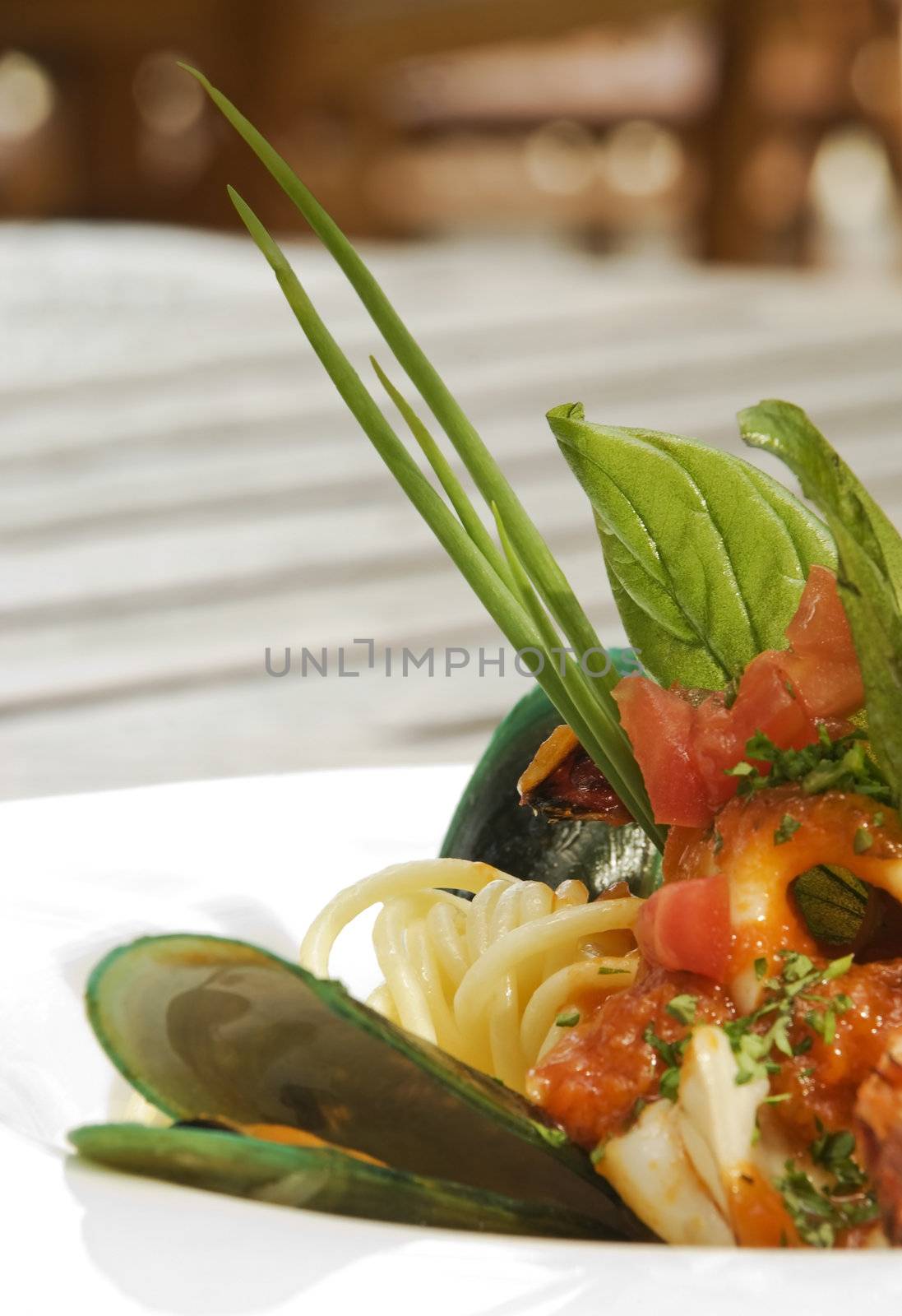 Oyster and sea food spaghetti with basil and served in a white ceramic plate