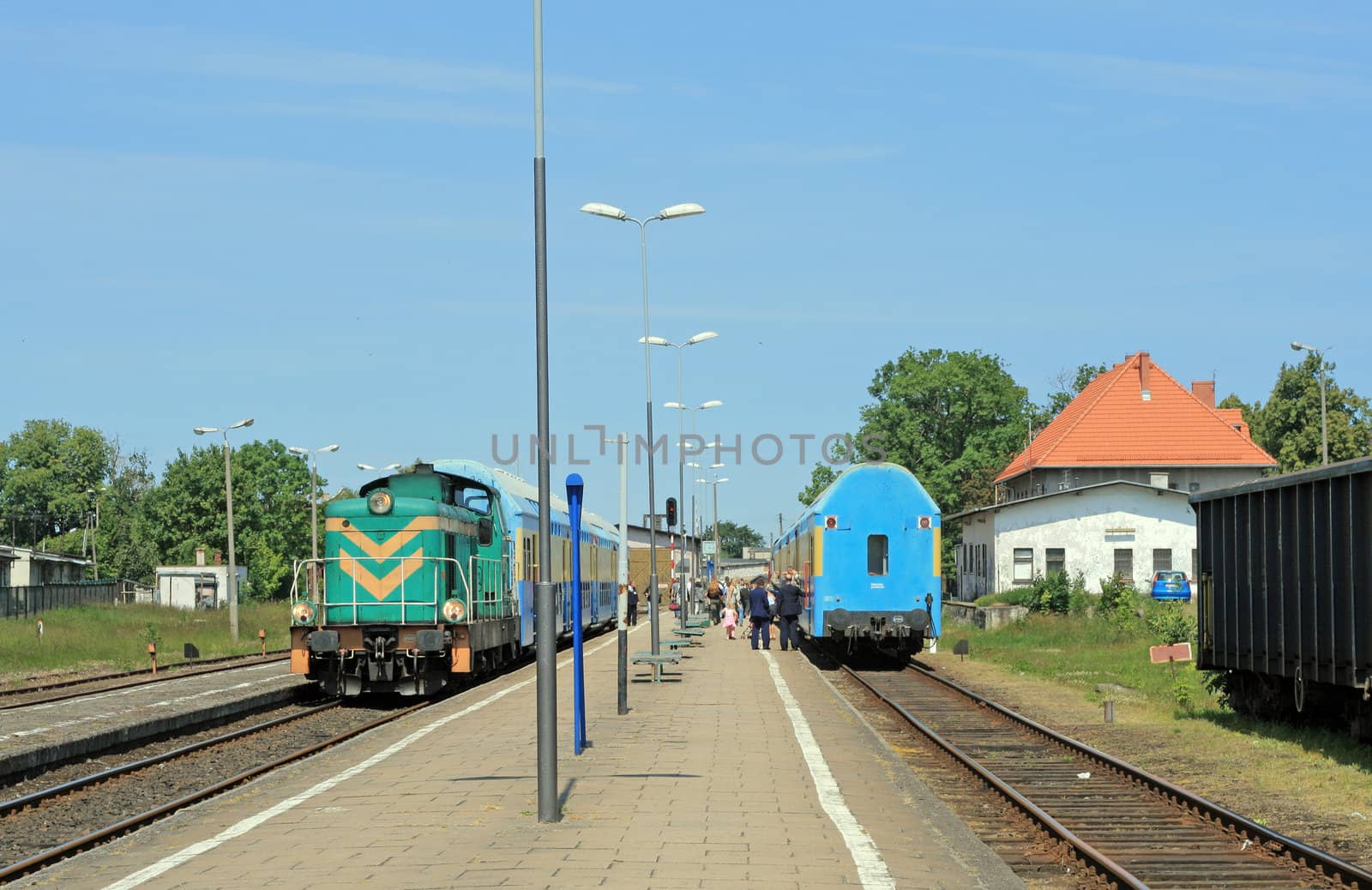 Two trains in opposite directions stopped at the small station
