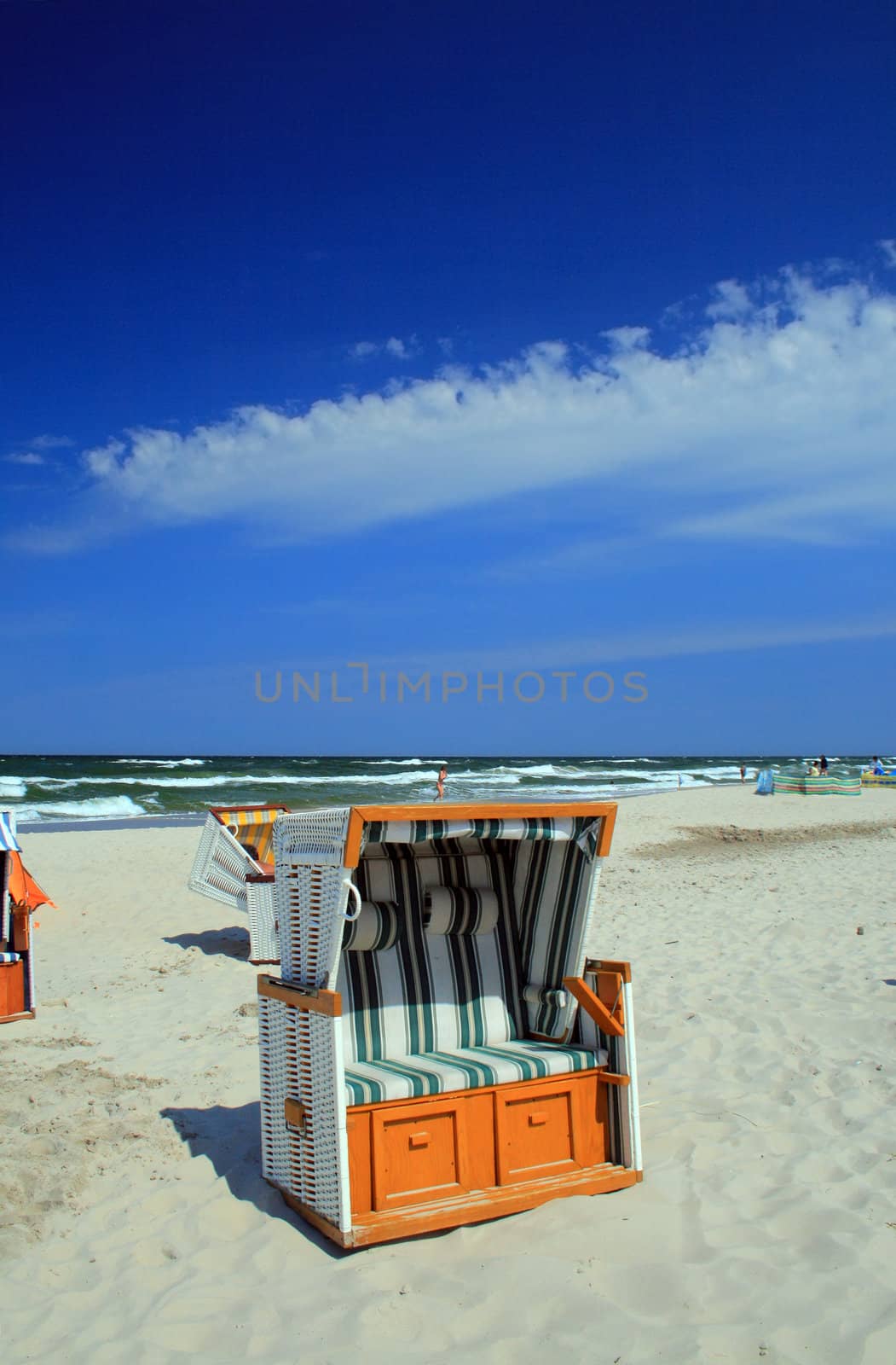 Wicker roofed beach chairs standing at the beach
