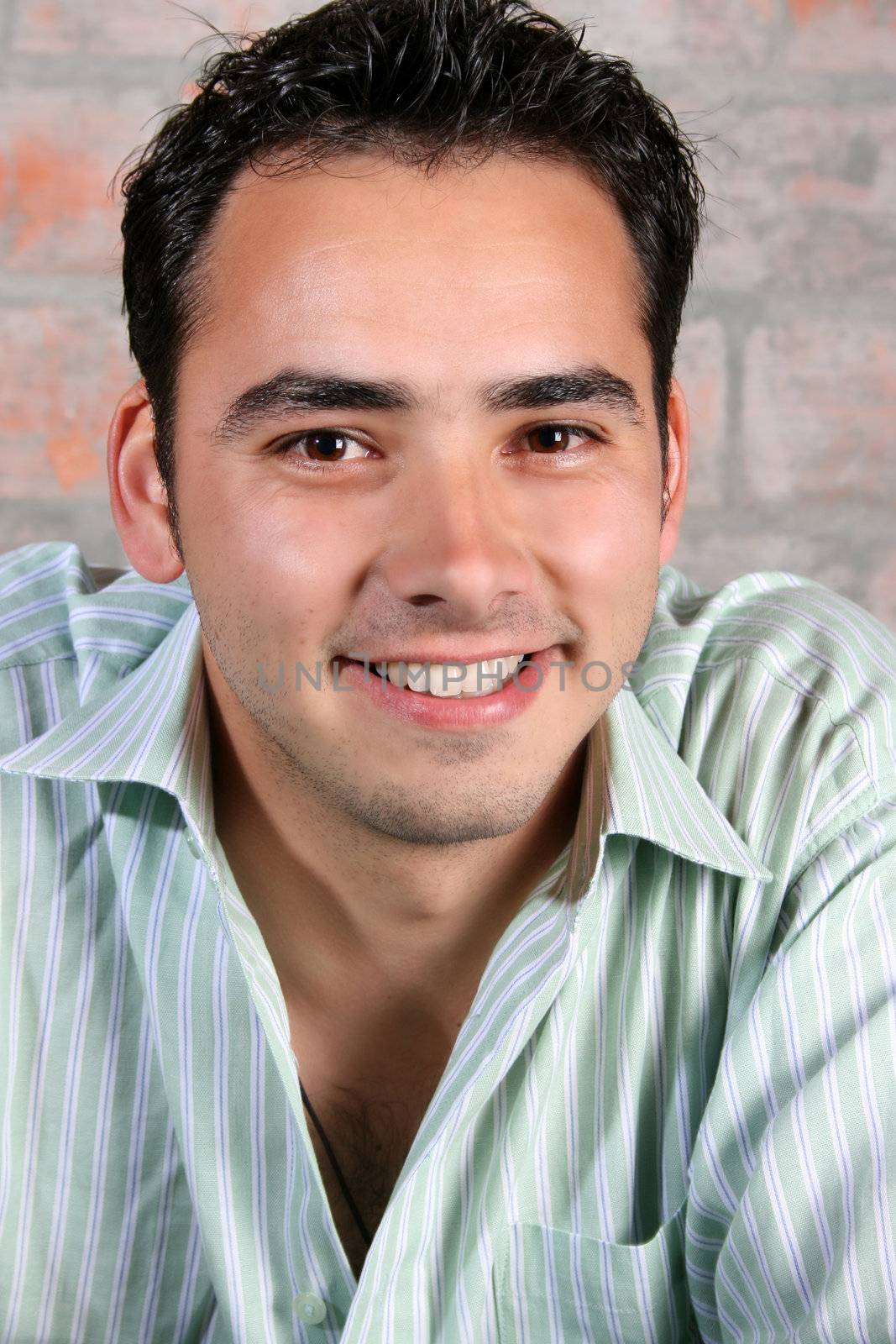 Male model against a rough brick wall background