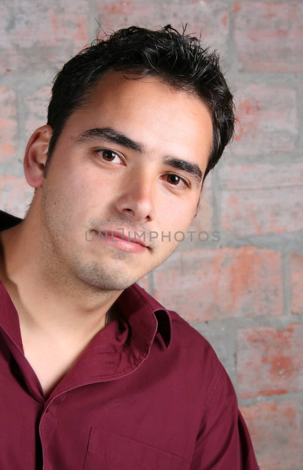 Male model against a rough brick wall background