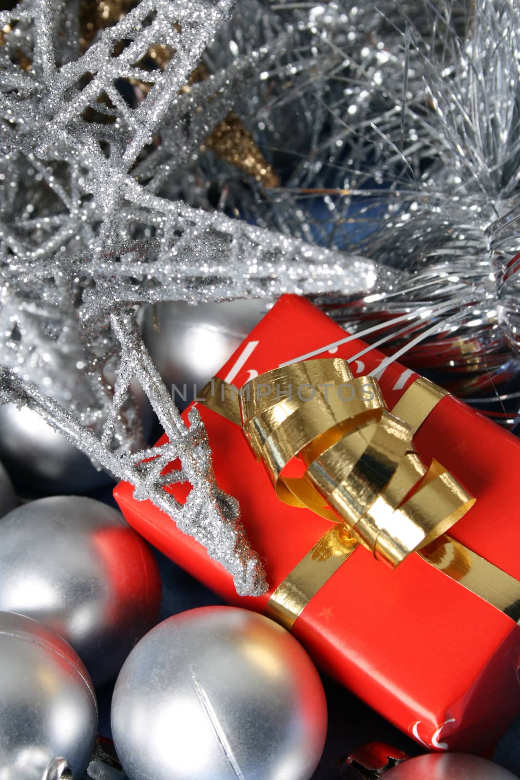 Small christmas gift amongst a variety of decorations