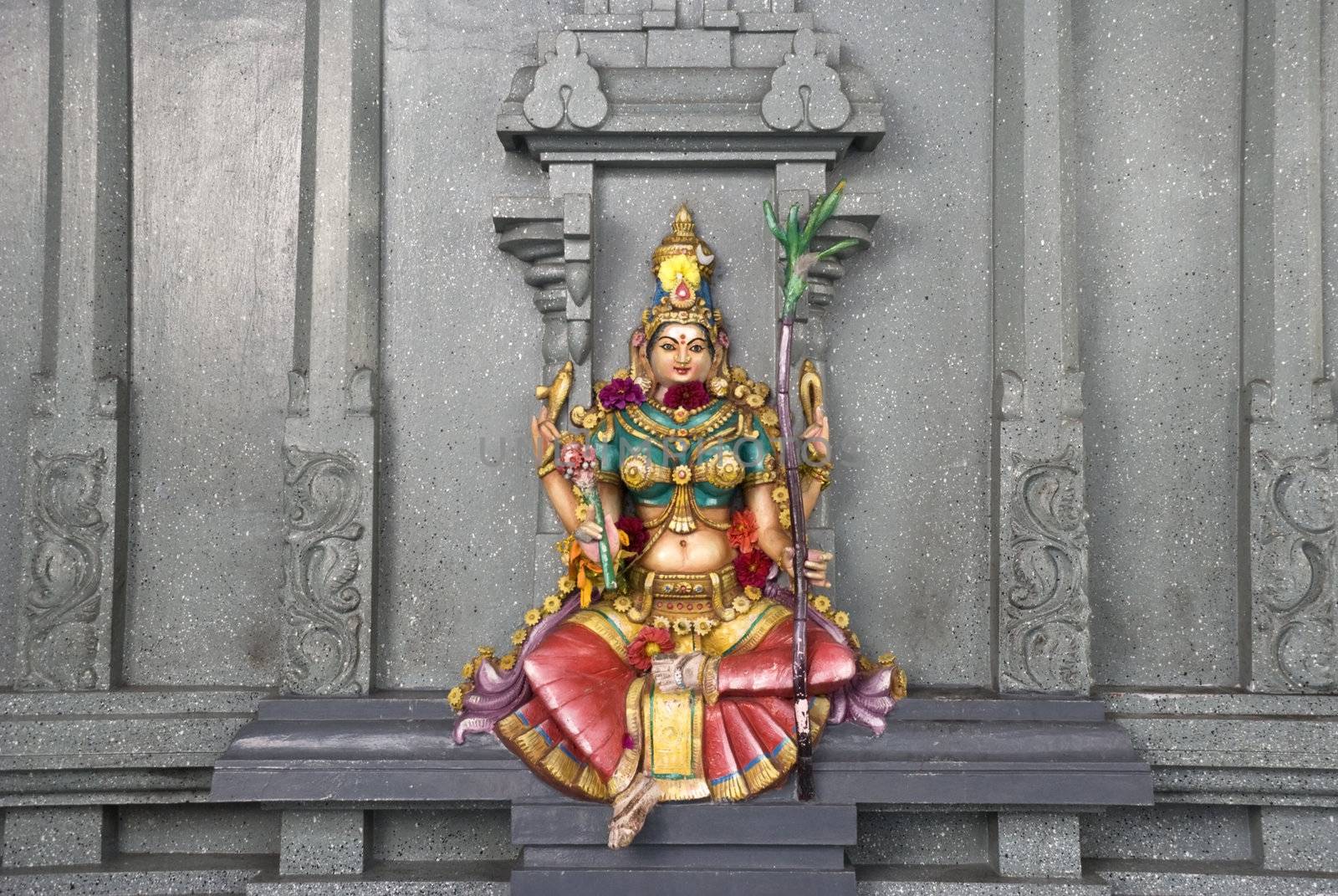 
A colorful stone wall statue of the Hindu deity Lakshmi, Goddess of wealth, prosperity, light, wisdom, fortune, fertility, generosity and courage; and the embodiment of beauty, grace and charm. 
