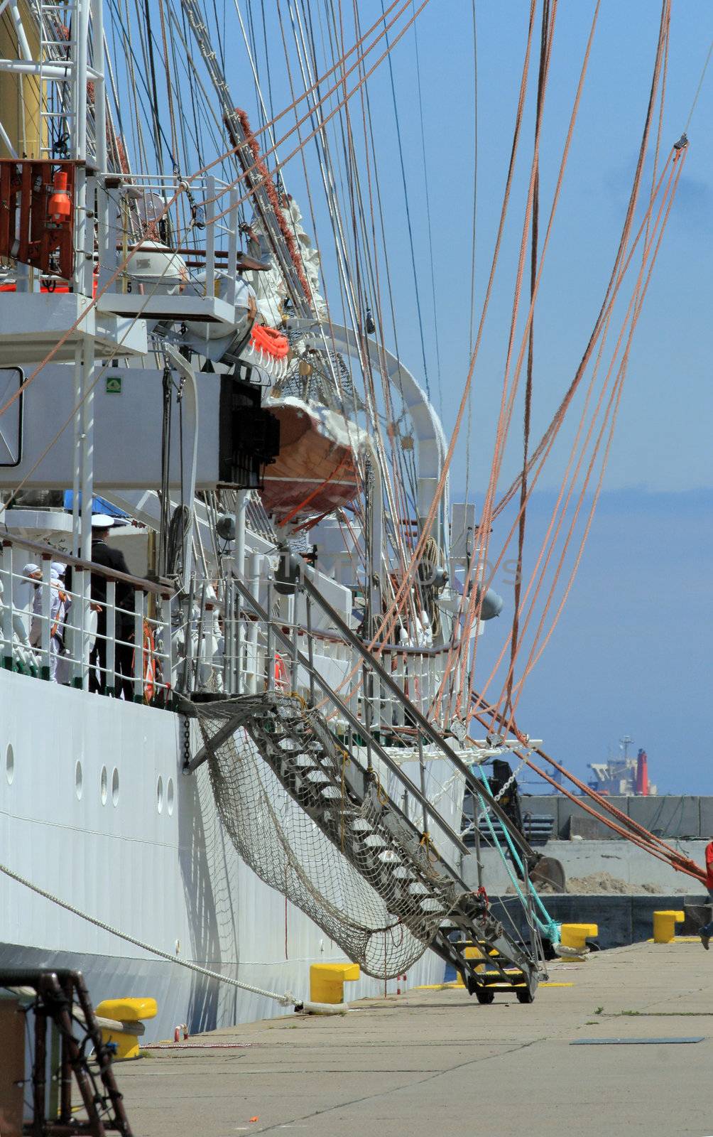 Side view of the historical yacht moored to the quay with ladder
