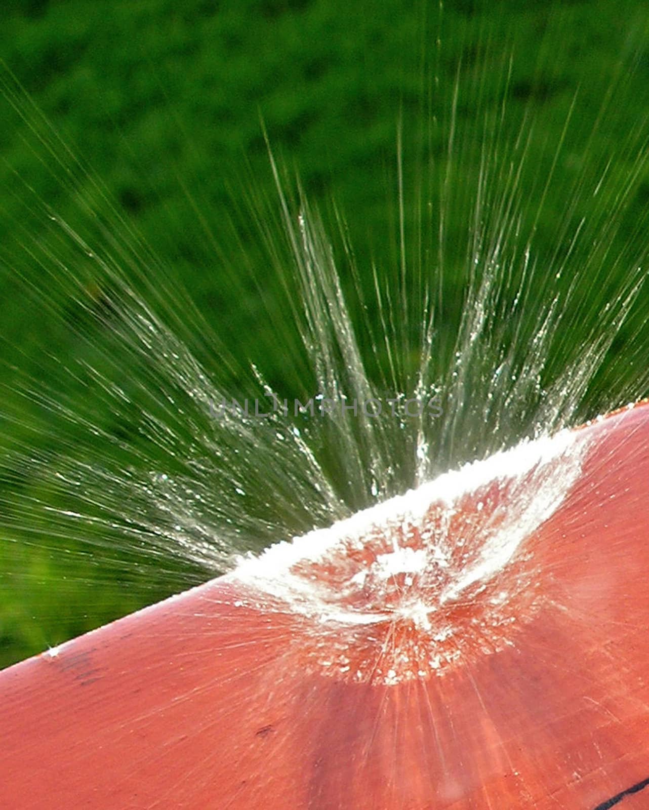 A drop hit my porch causing a big splash of water... Actually it is small, but the closeup makes it look big