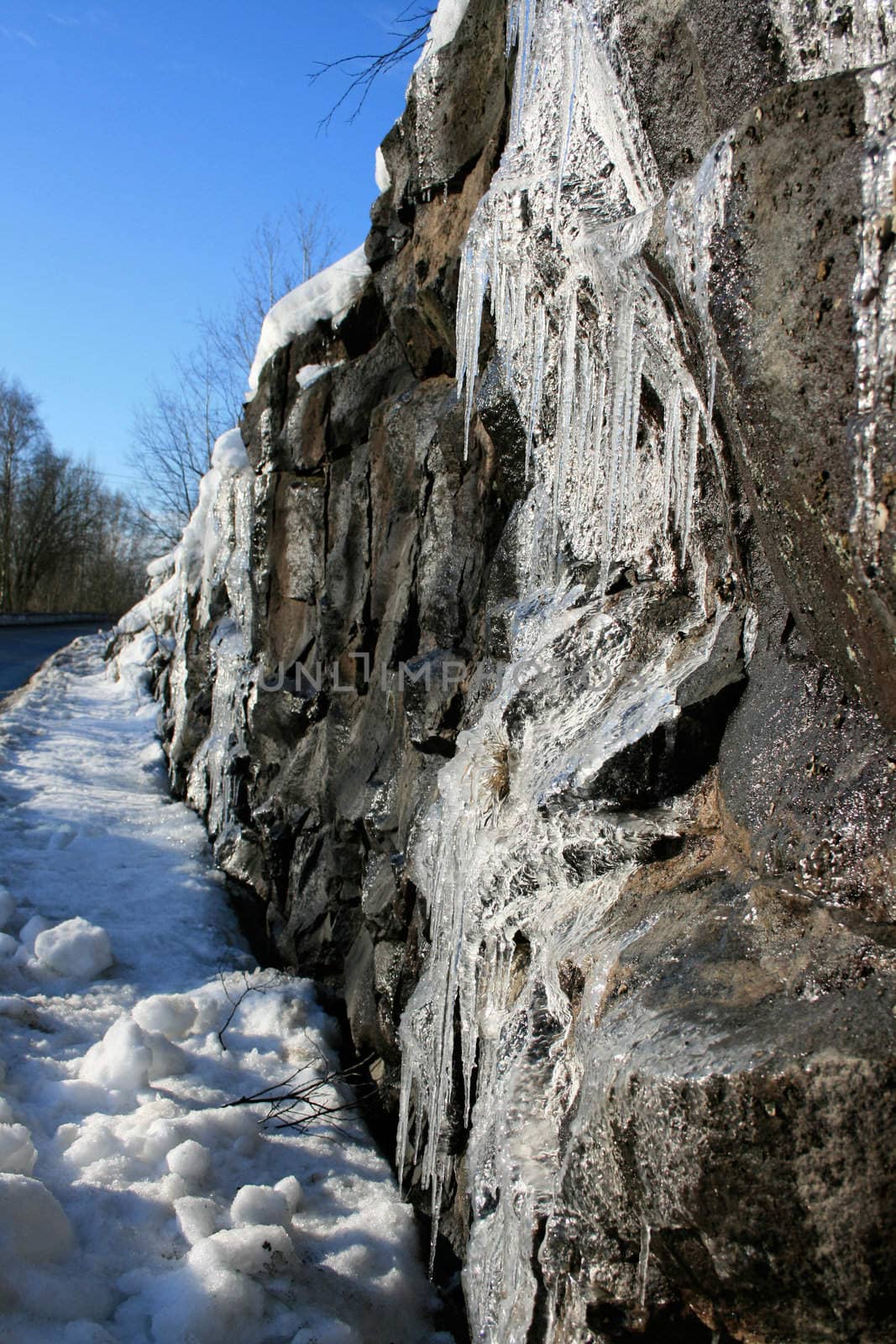 Icicles hanging from a rock