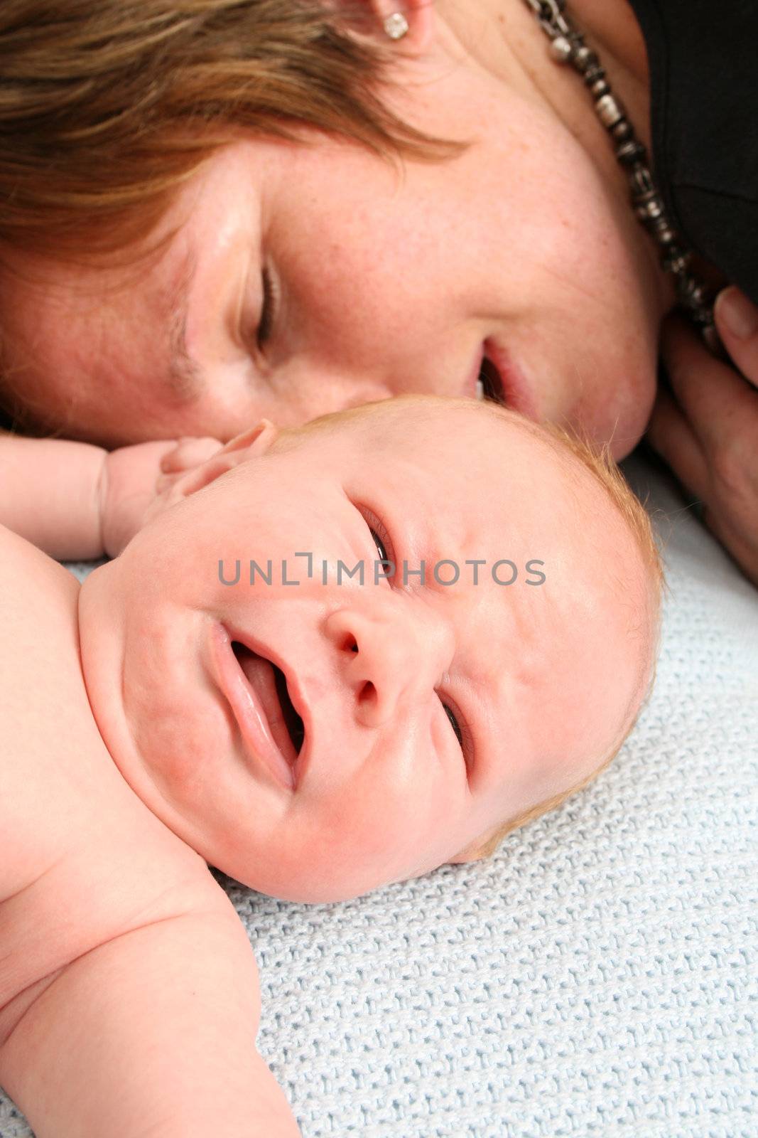 Tired mother and crying newborn baby, both fed-up