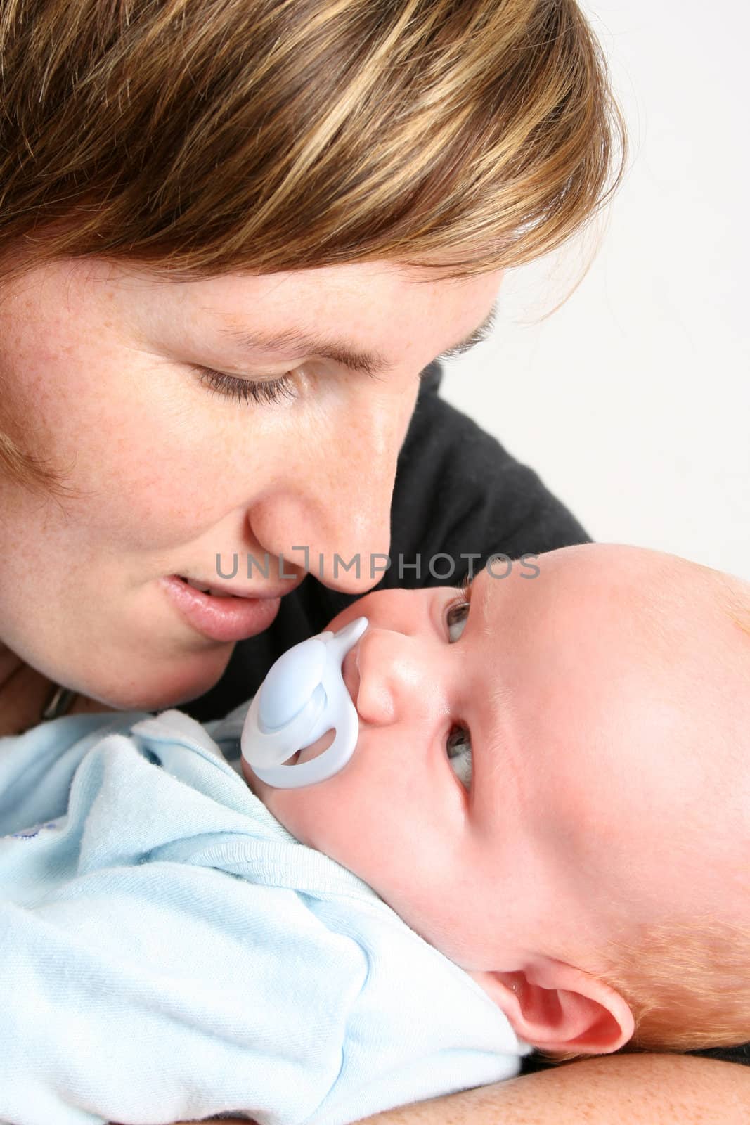Loving mother holding her new baby boy