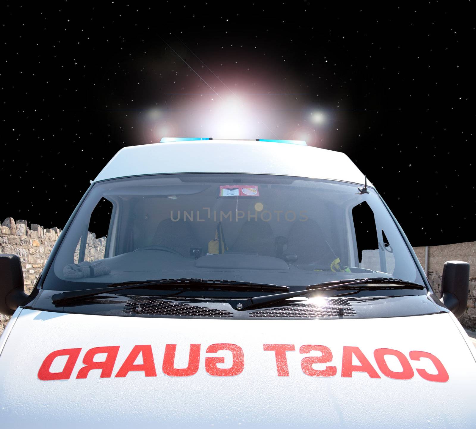 the front of a coast guard vehicle at night with flashing lights