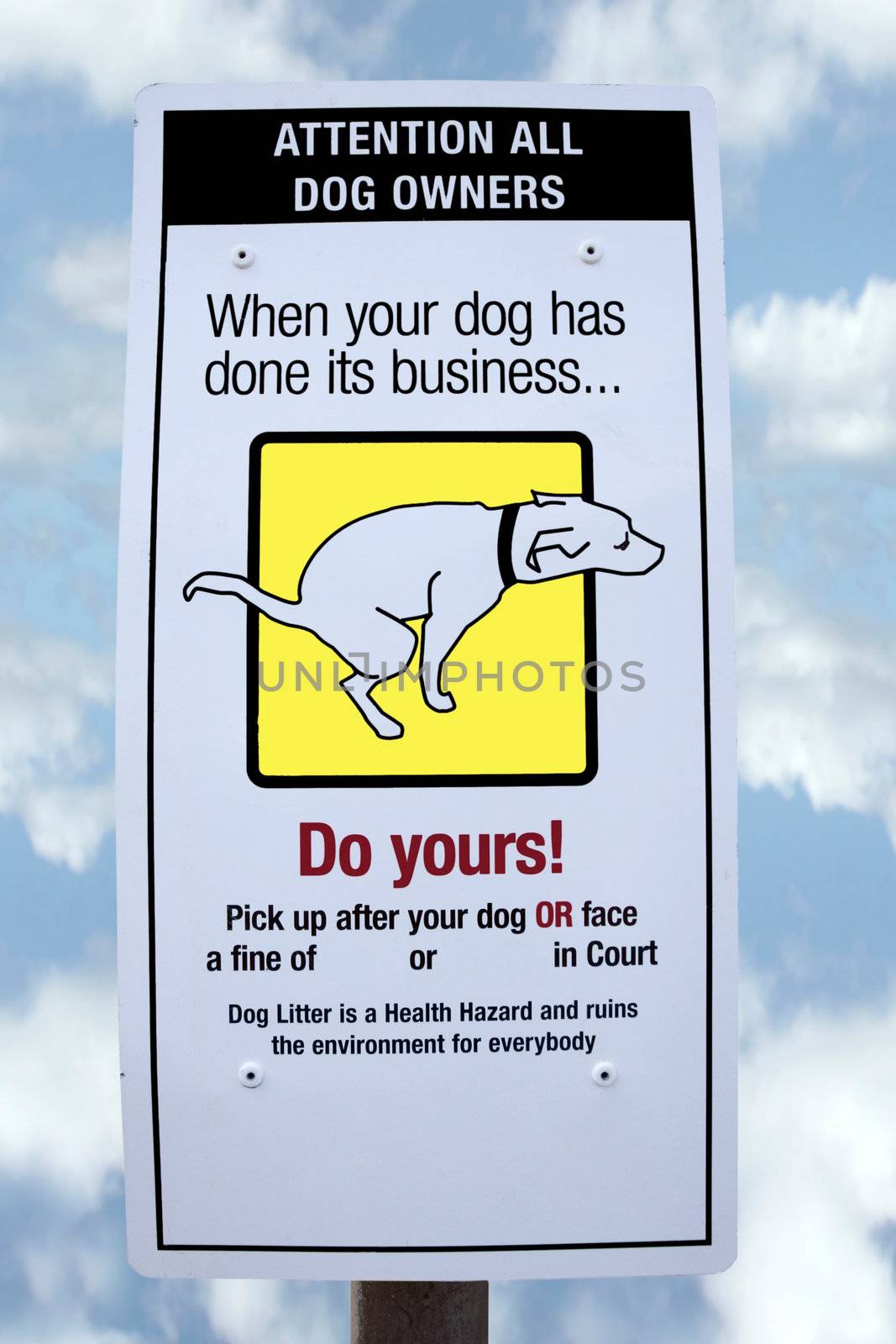sign warning about fines for dogs fouling with cloudy background