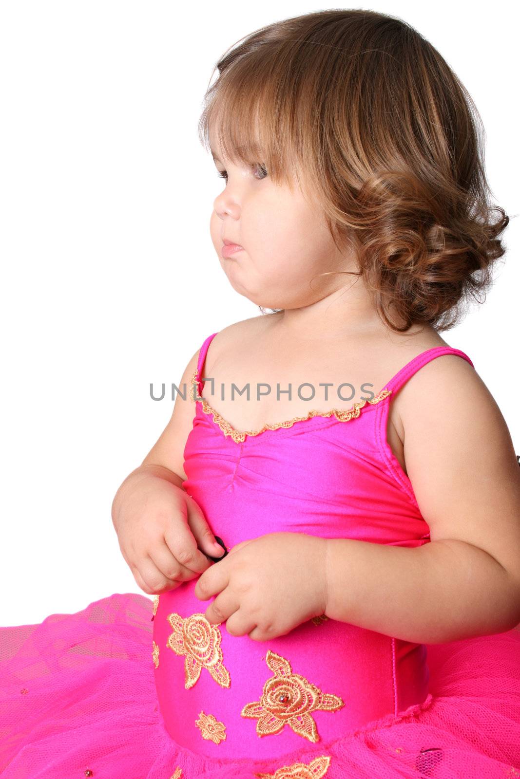 Little girl with short hair wearing a bright pink ballet outfit
