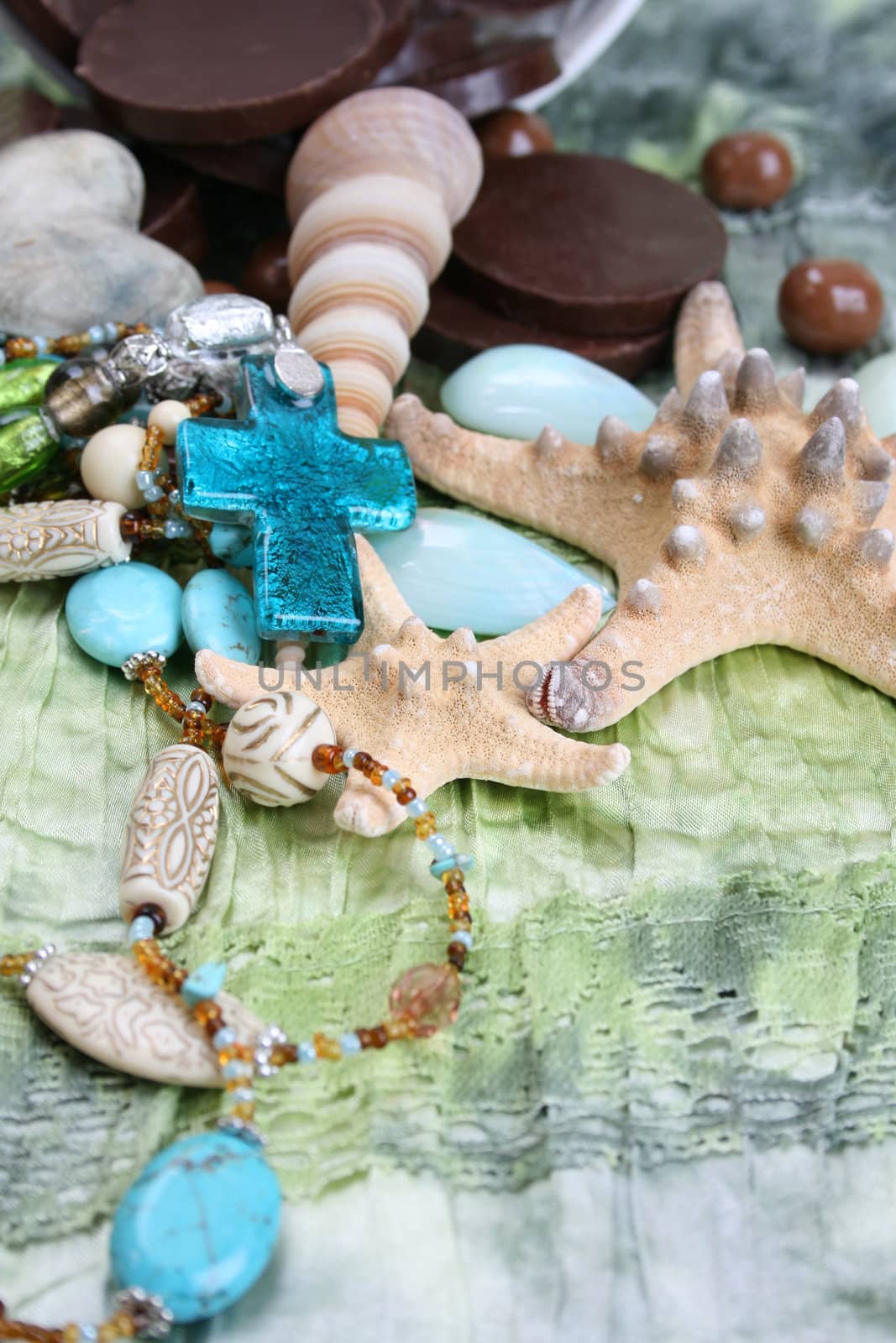 Chocolates, Seashells and jewellery on a seagreen cloth