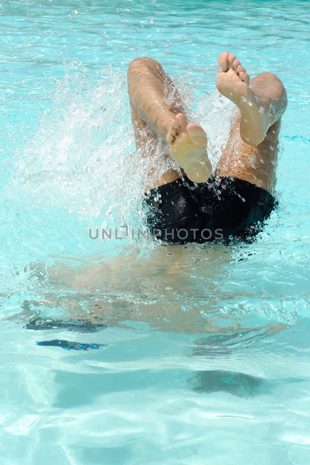 Man is diving in a swimming pool
