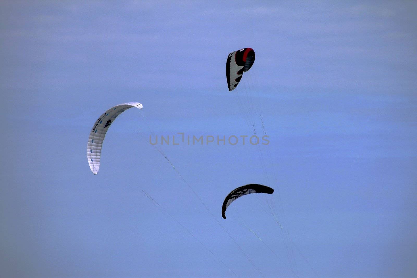 Surfboard kites flying of a summer beach