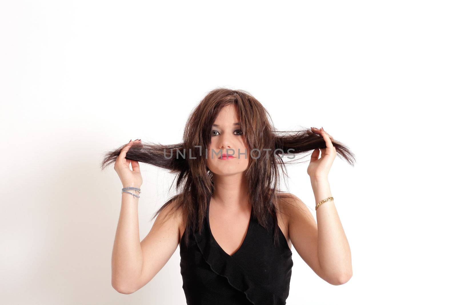 Young pretty teenage girl brunette in studio with long hair