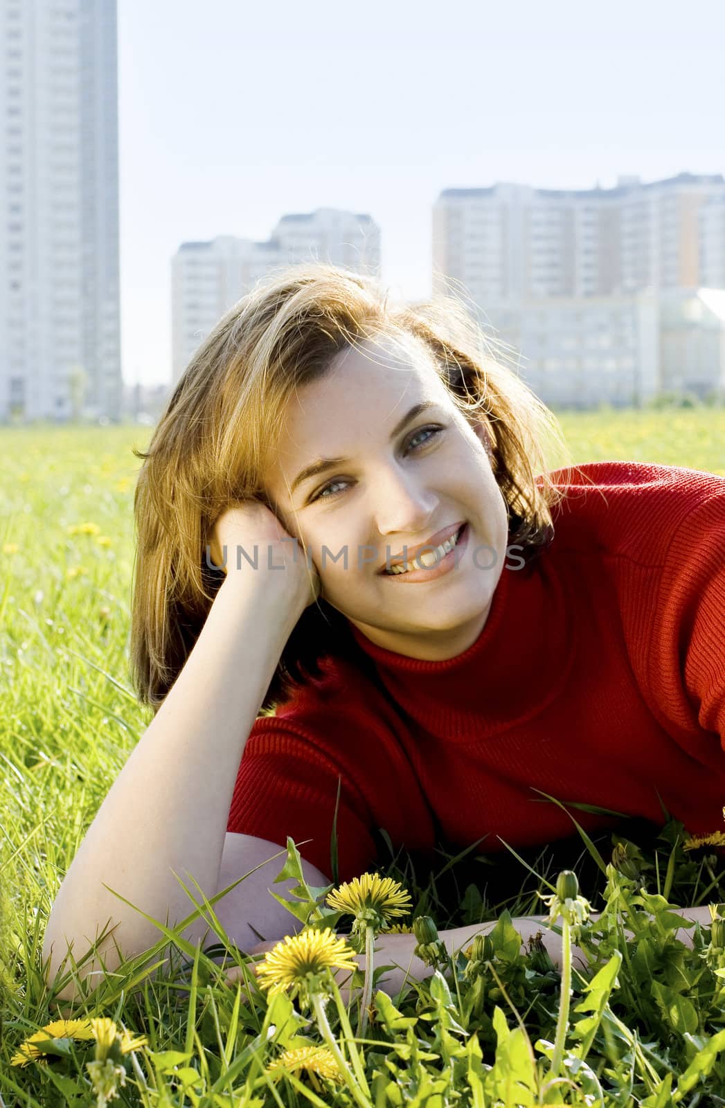 Woman in red jacket on summer's meadow.