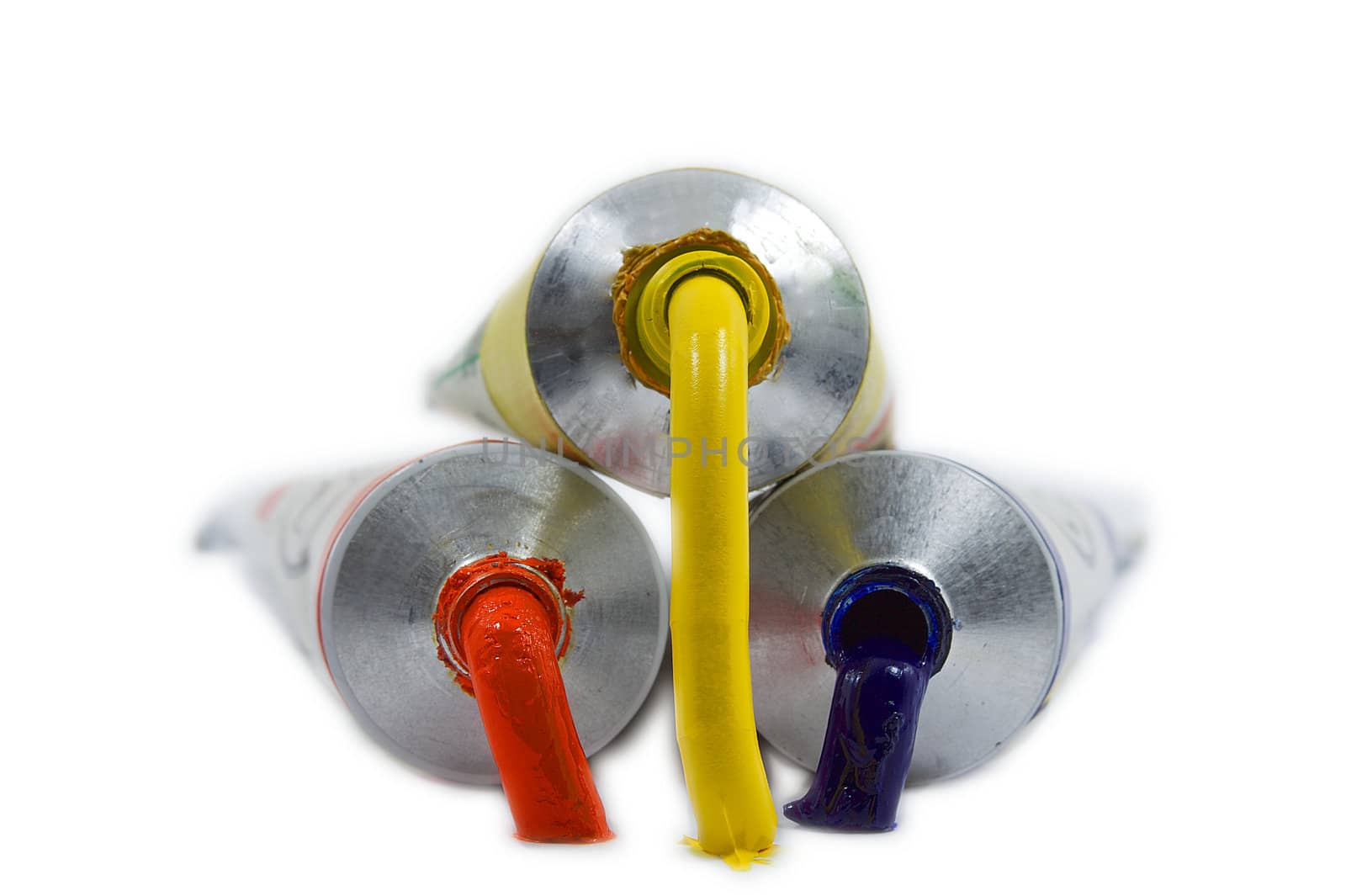 Ouzing paint pyramid  from a red, yellow, amd blue oil paint tubes visolated
