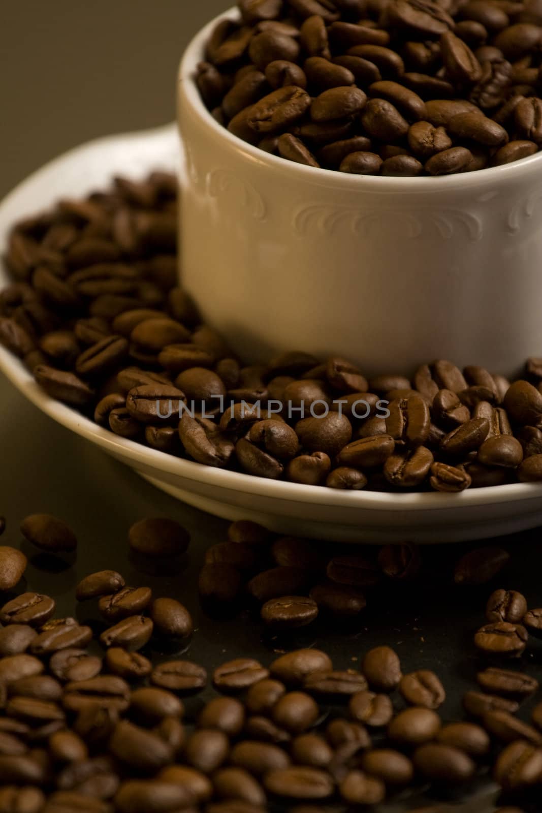 Tasty coffee with plenty of roasted coffee beans around.