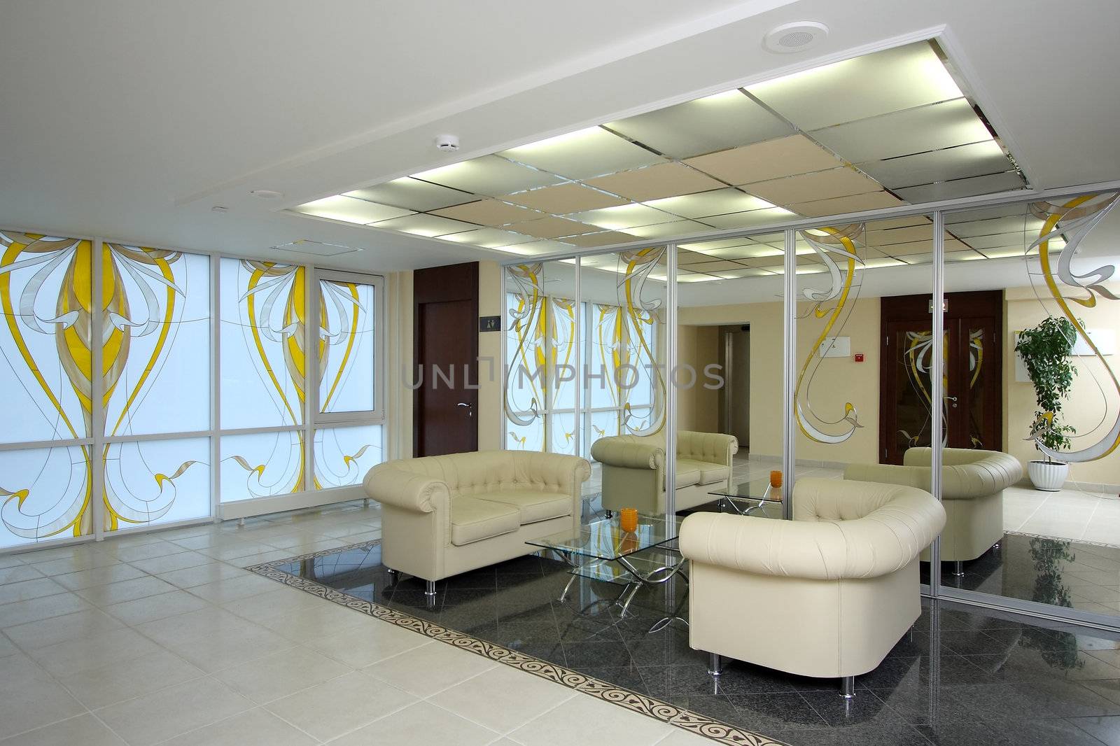 Lobby of hotel with sofas and a mirror