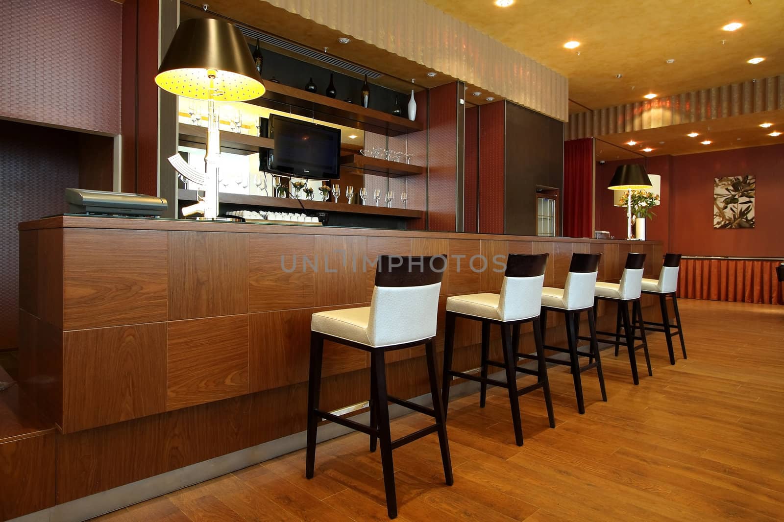 Wooden bar rack with a number of high chairs