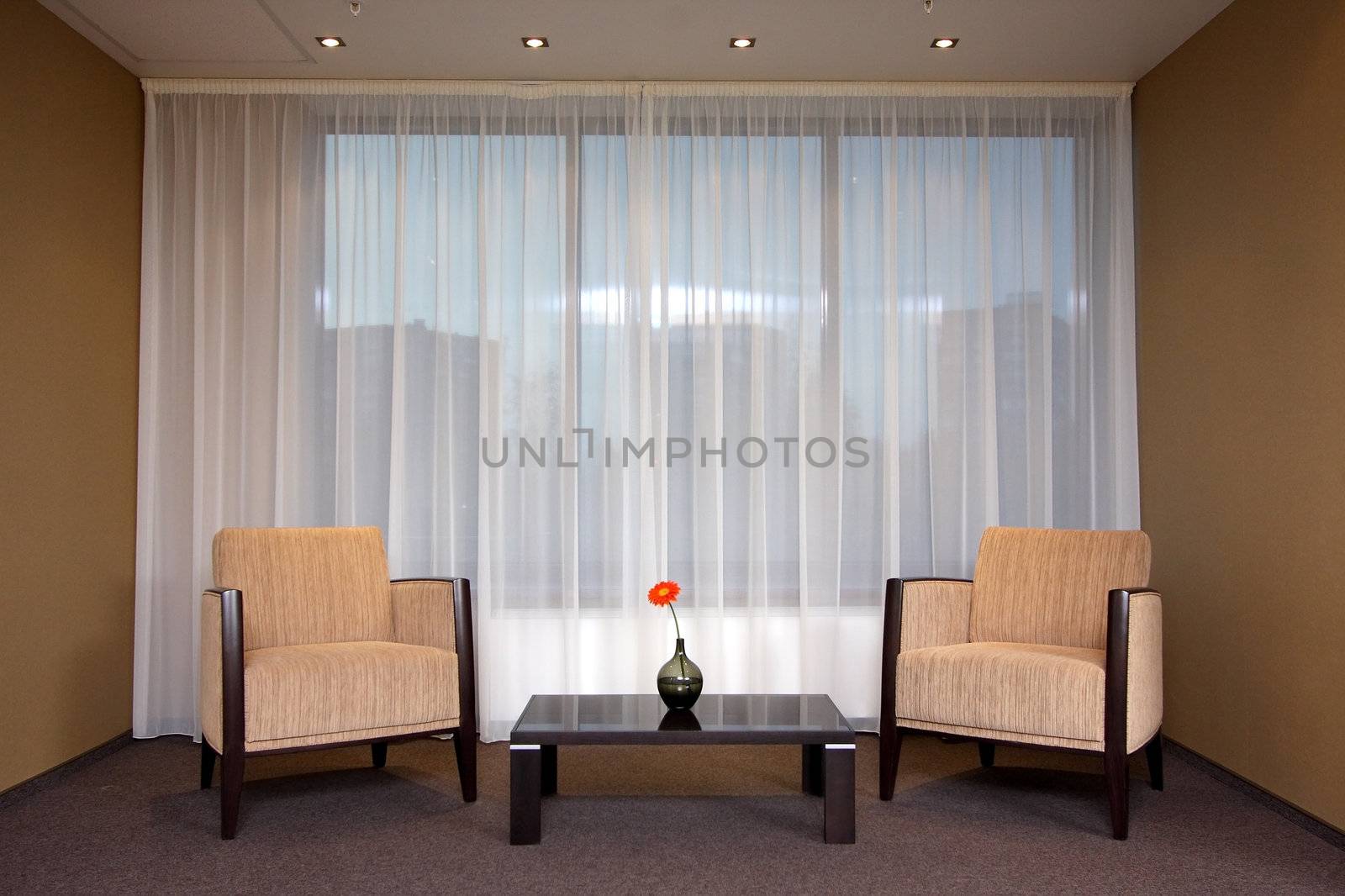 Lobby of hotel with sofas and a window