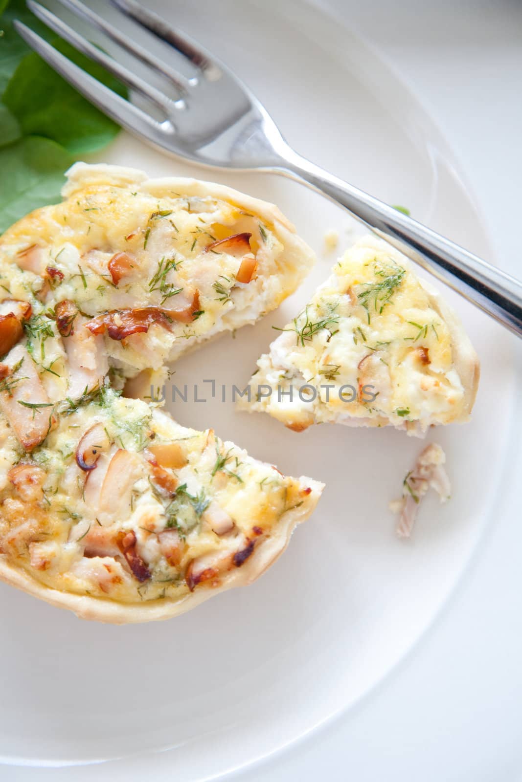 Small quiche filled with smoked chicken, feta and dille