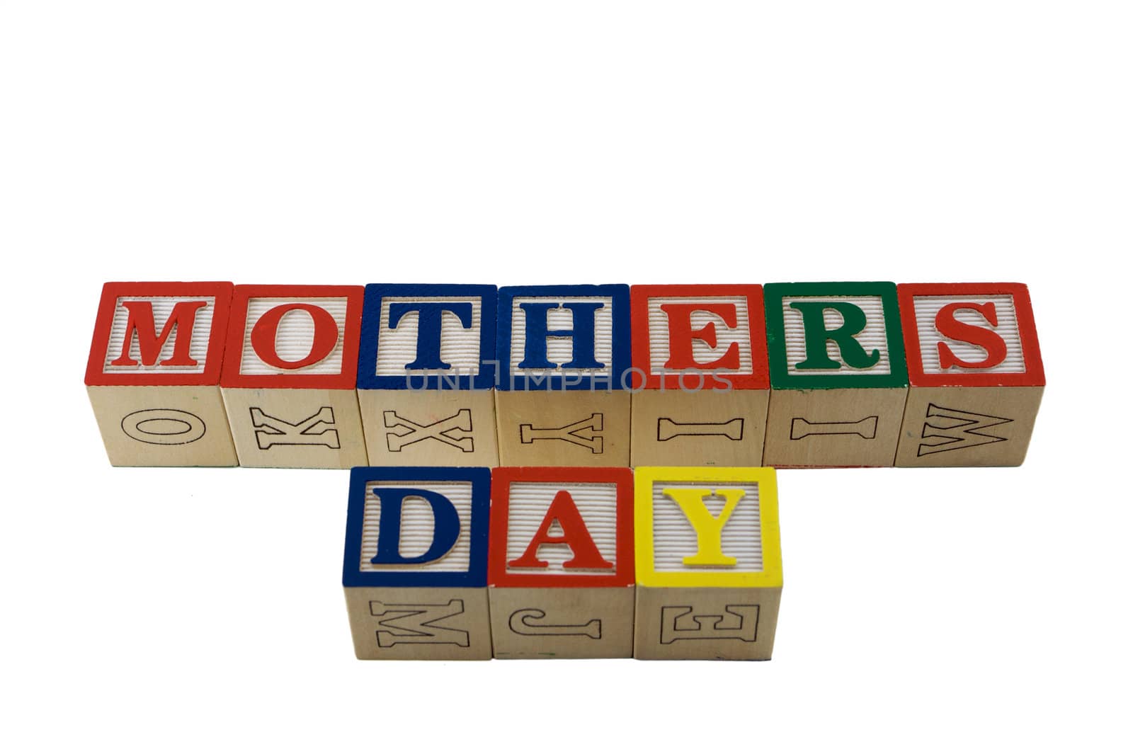 wooden alphabet blocks lined up in a row spelling Mothers Day in two rows