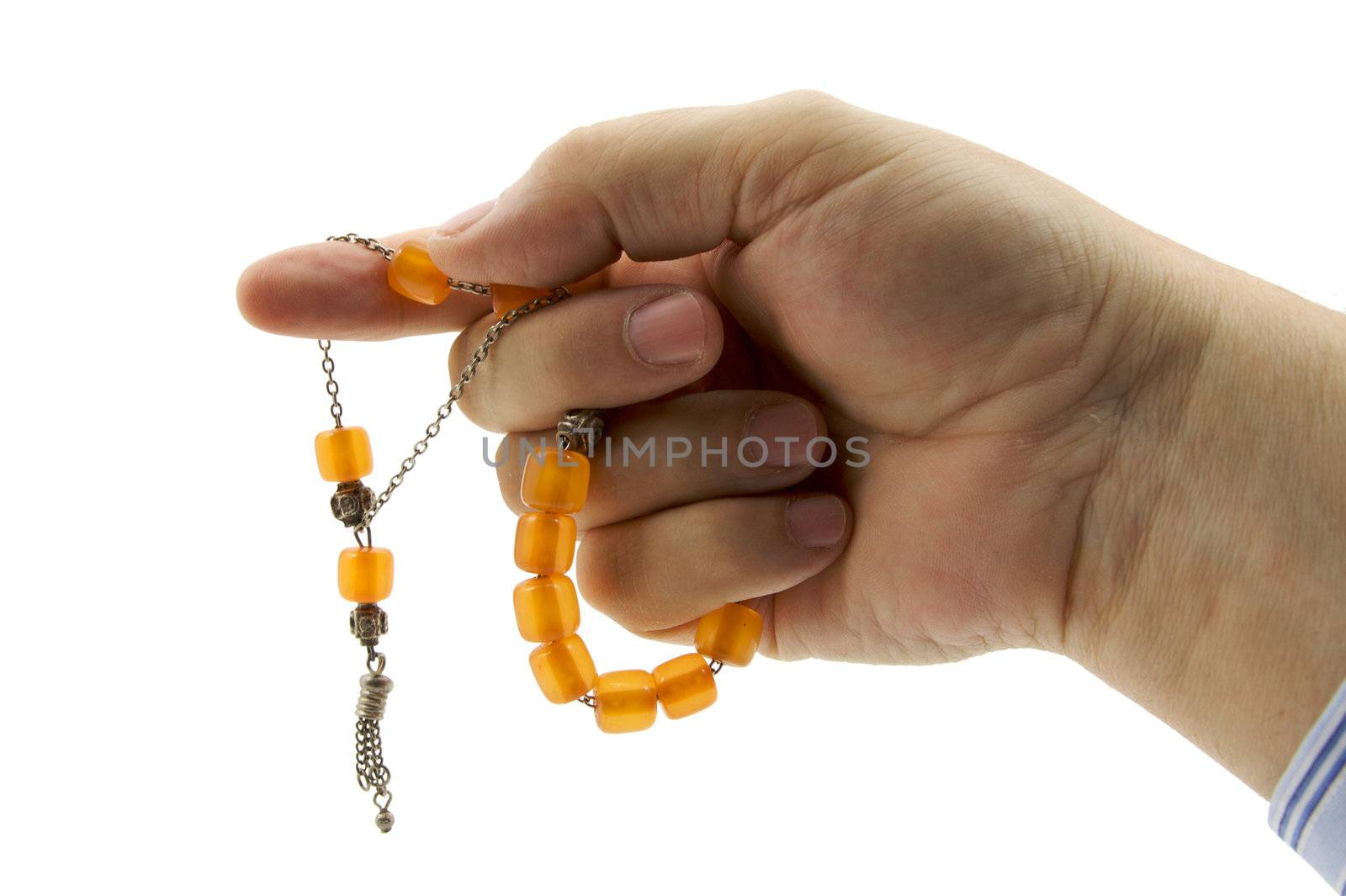 amber greek worry beads being counted in a hand