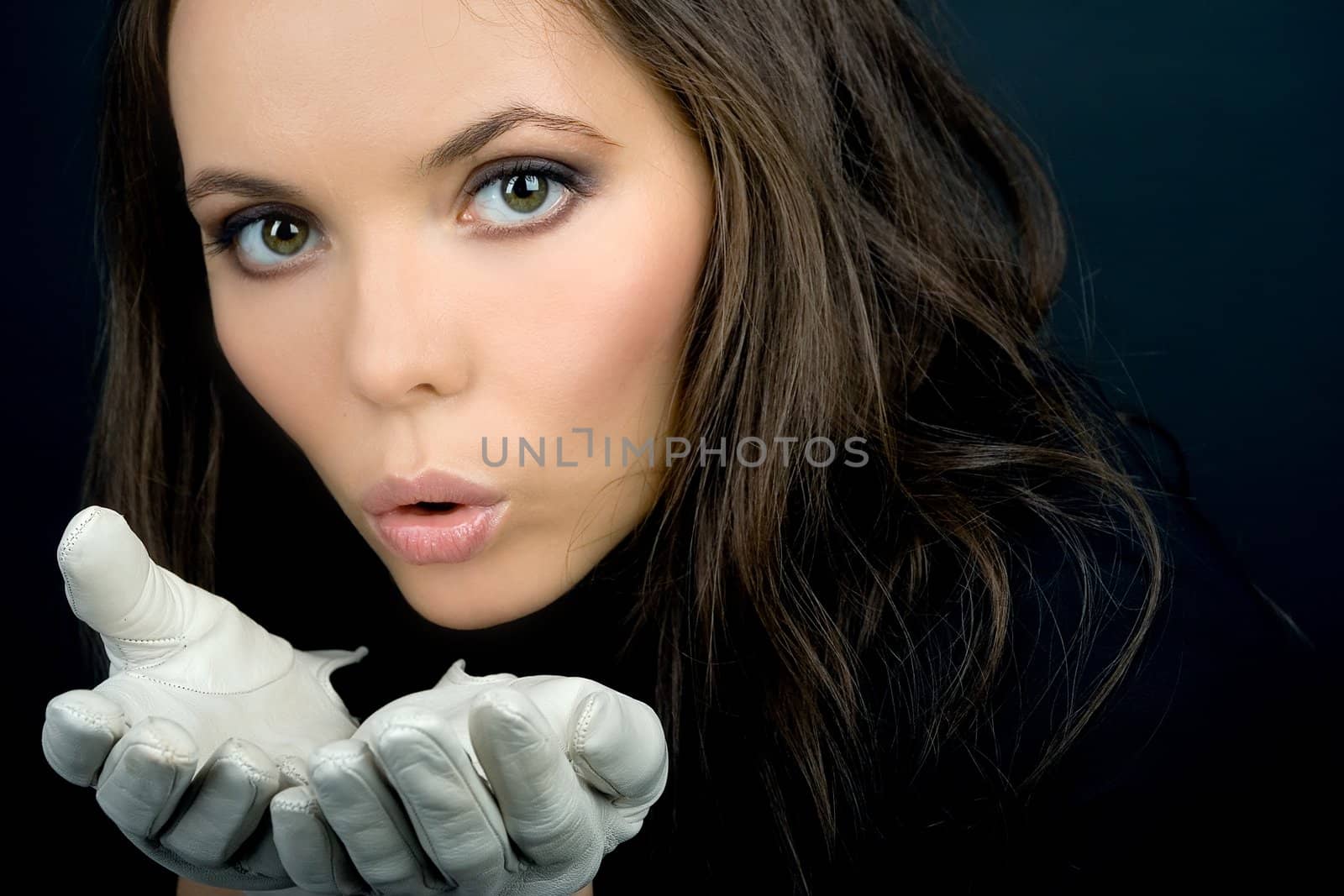 Charming blowing woman in white gloves