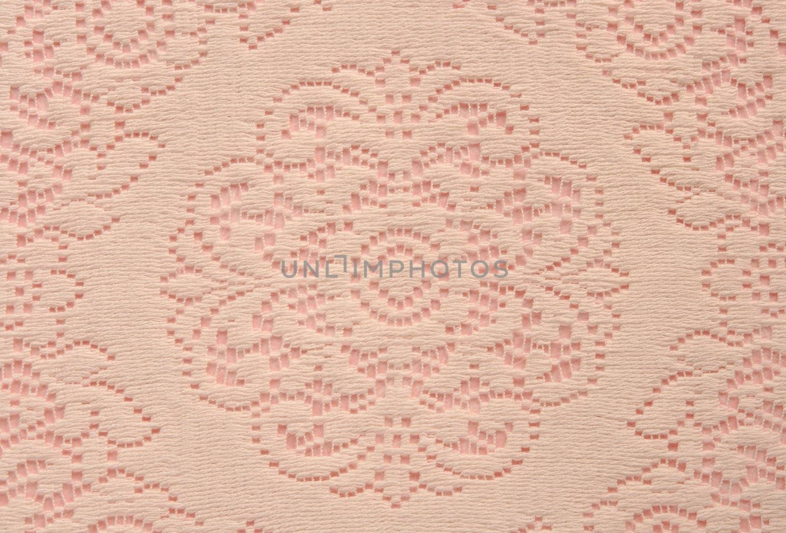beige lace doily on pink useful for a background